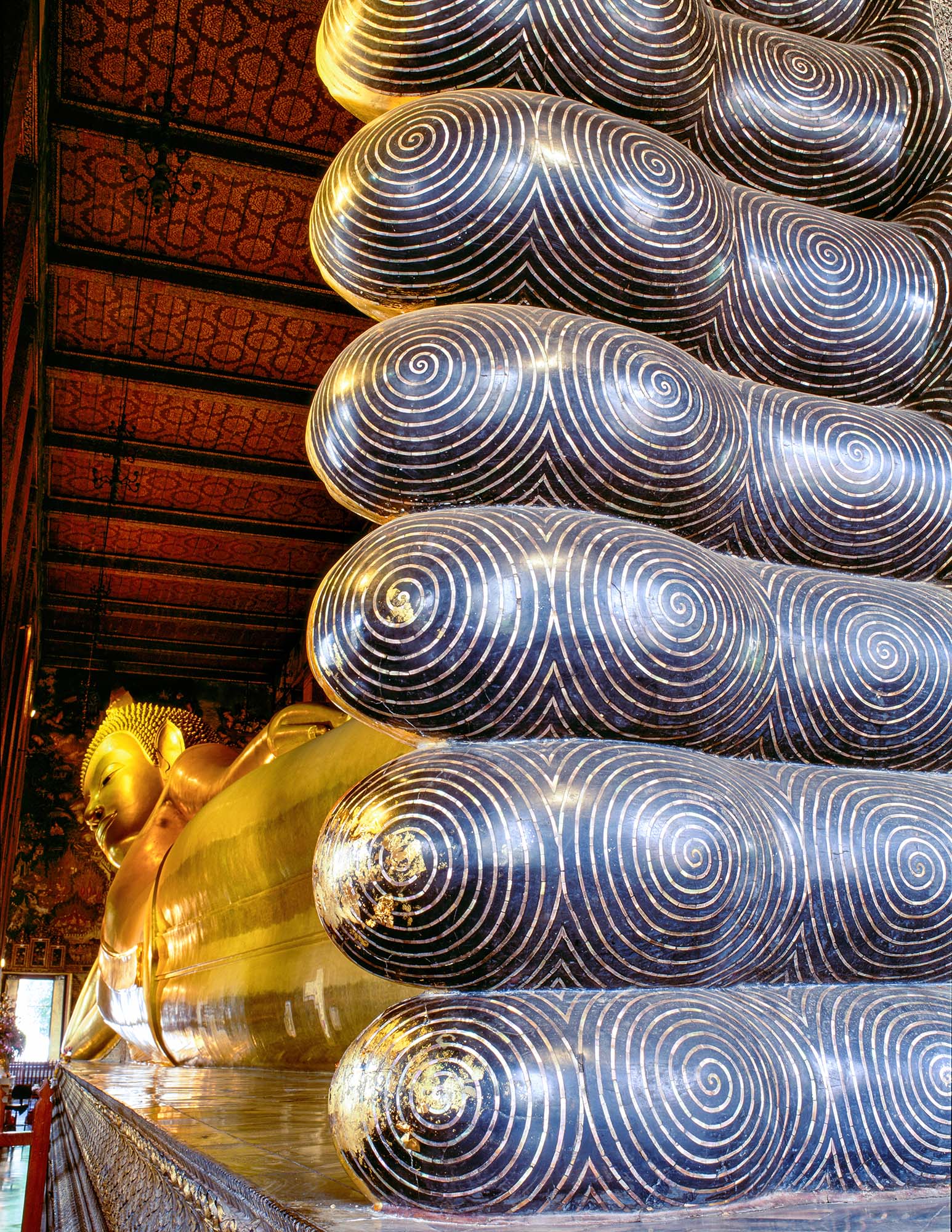 Wat Pho holds Thailand's largest reclining Buddha. This gold plated Buddha is 46 meters long and 15 meters high, and illustrates...