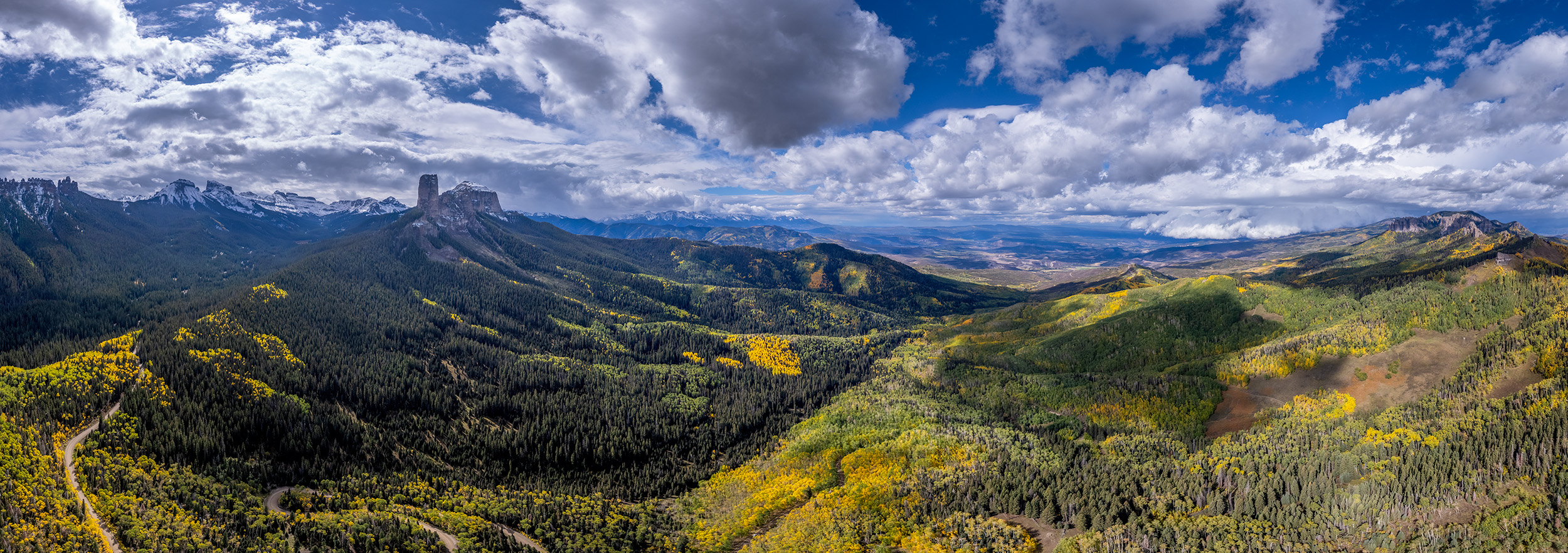 Autumn's Embrace: Owl Creek Pass Panorama This panoramic image, captured from a lofty drone vantage point above Owl Creek Pass in Colorado, offers a sweeping view of nature...