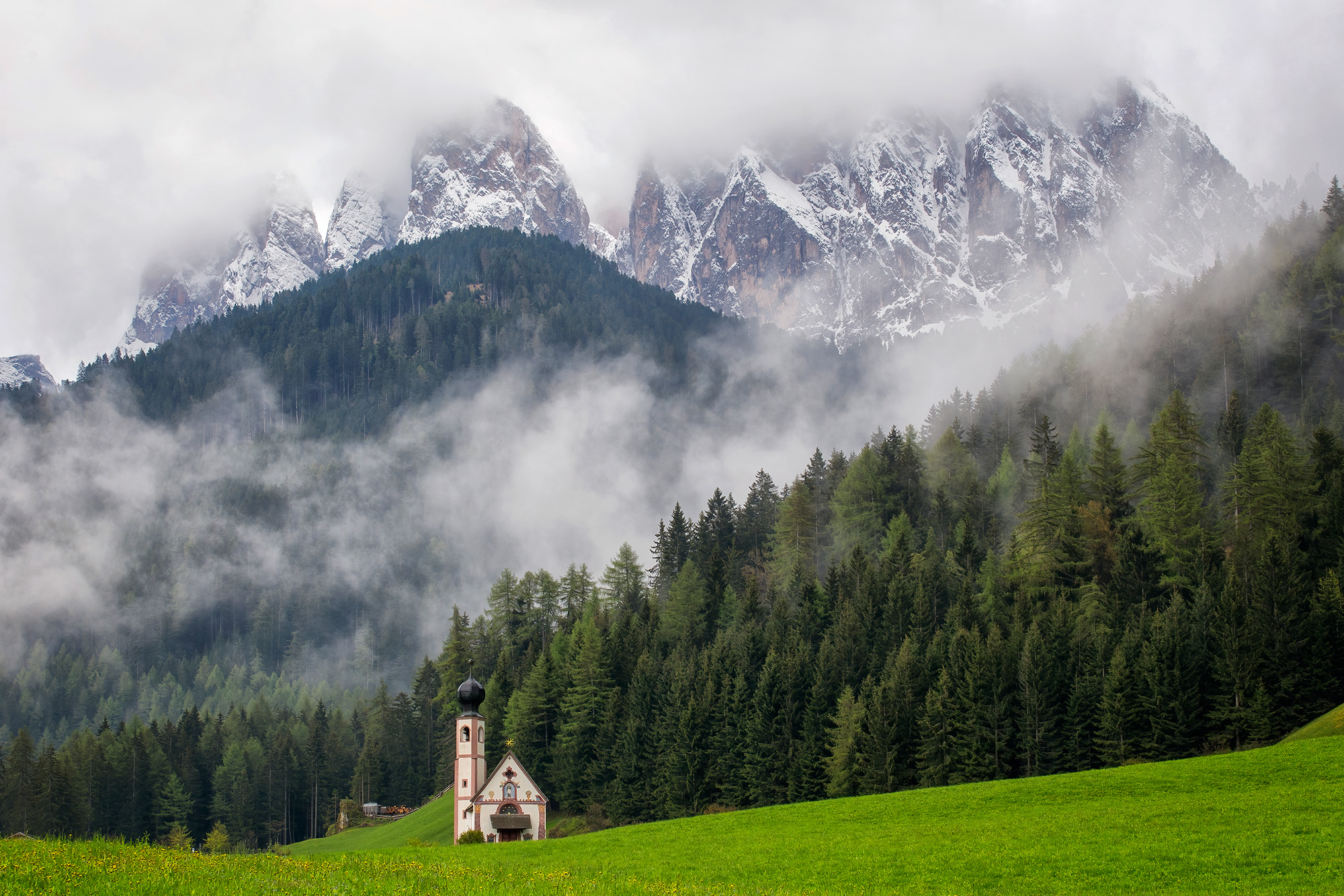 Nestled in the heart of the Italian Dolomites, St. Johann Church graces a tranquil valley floor. This image beautifully frames...