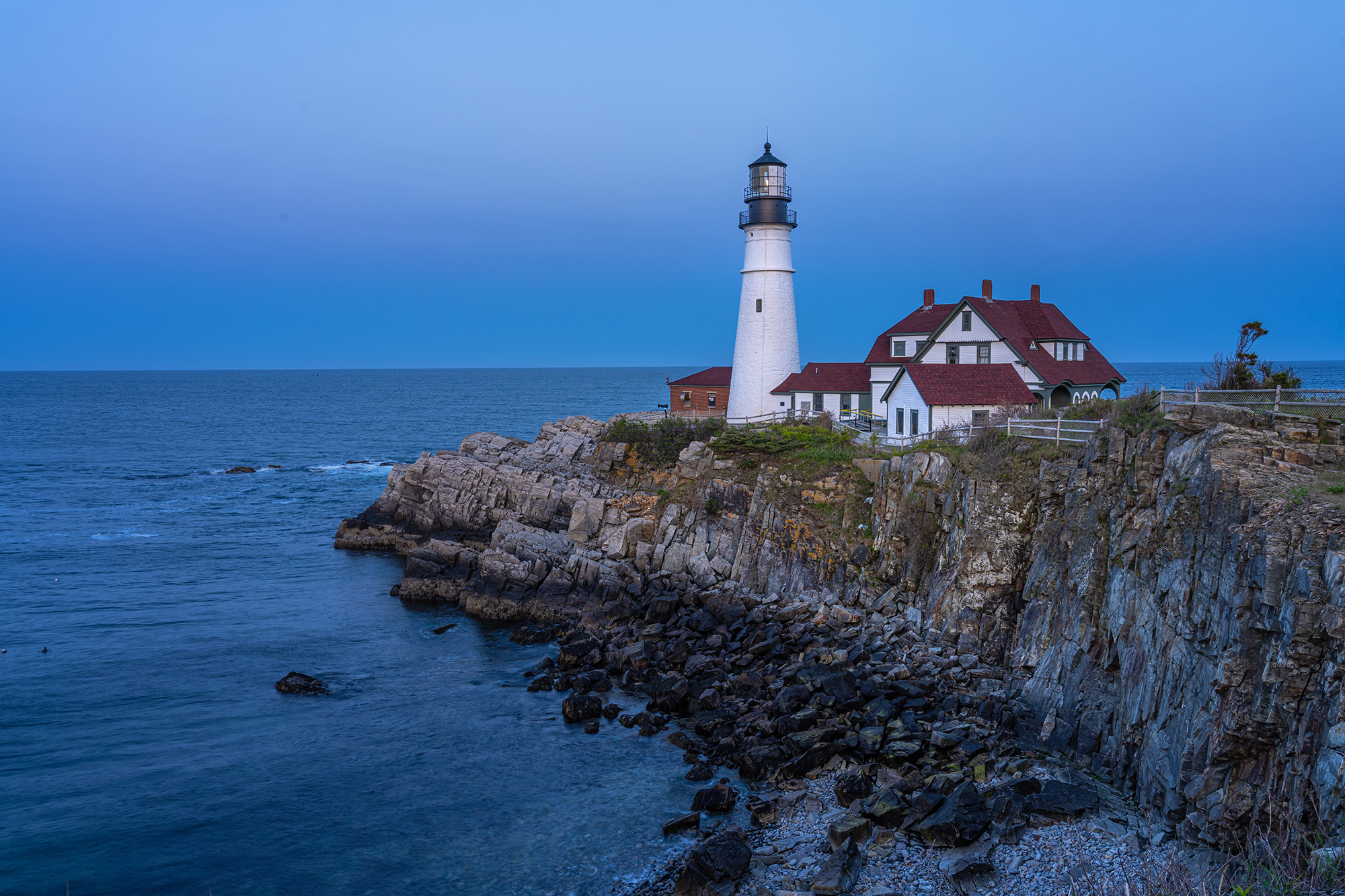 "Coastal Luminescence" captures the timeless beauty of Portland Head Lighthouse in Maine. During the fleeting blue hour, I seized...