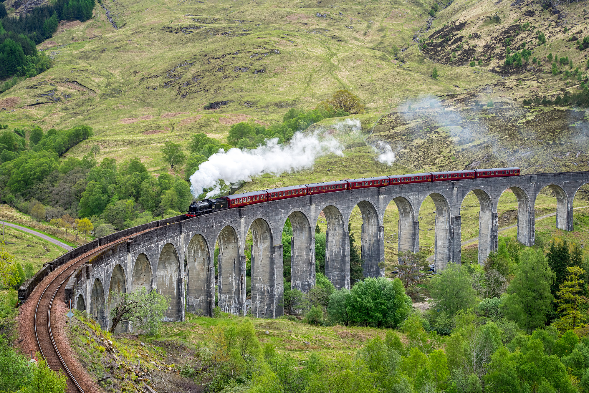 "Steam Journey Across Glenfinnan Viaduct" showcases the iconic Glenfinnan Viaduct in Scotland. This remarkable structure, often...
