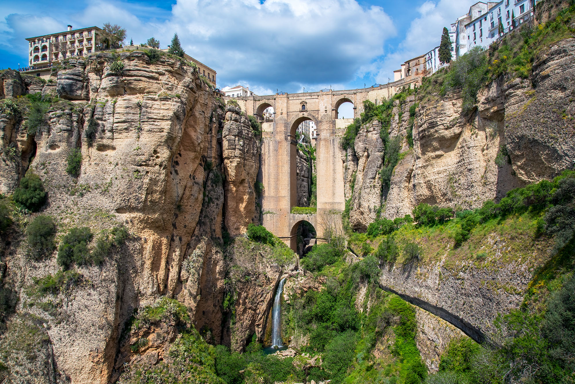 From below the historic town of Ronda, Spain, I gazed upward at the Puente Nuevo Bridge, a magnificent span that links the town...