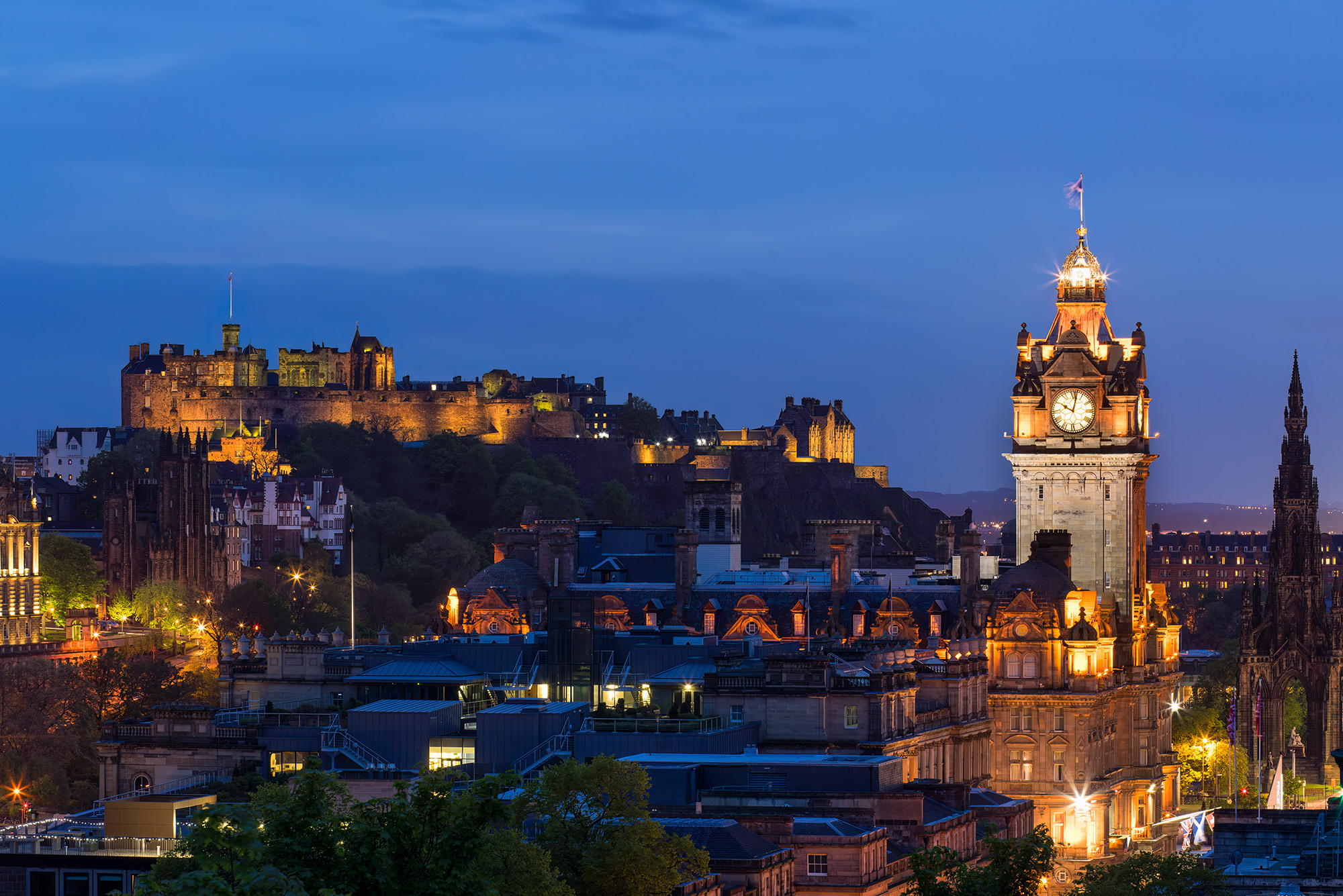 This image, captured during  blue hour, emanates the charm of Edinburgh, Scotland. From the vantage point of Calton Hill, the...