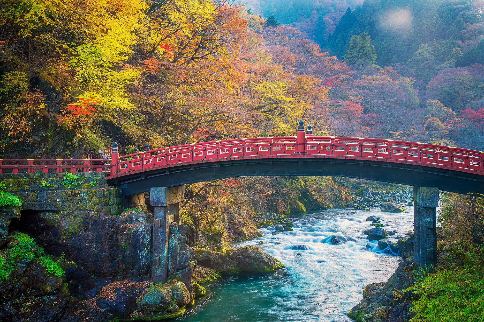 Captured during the height of autumn's brilliance in Nikko, Japan, this image showcases the resplendent Shinkyo Bridge. Spanning...