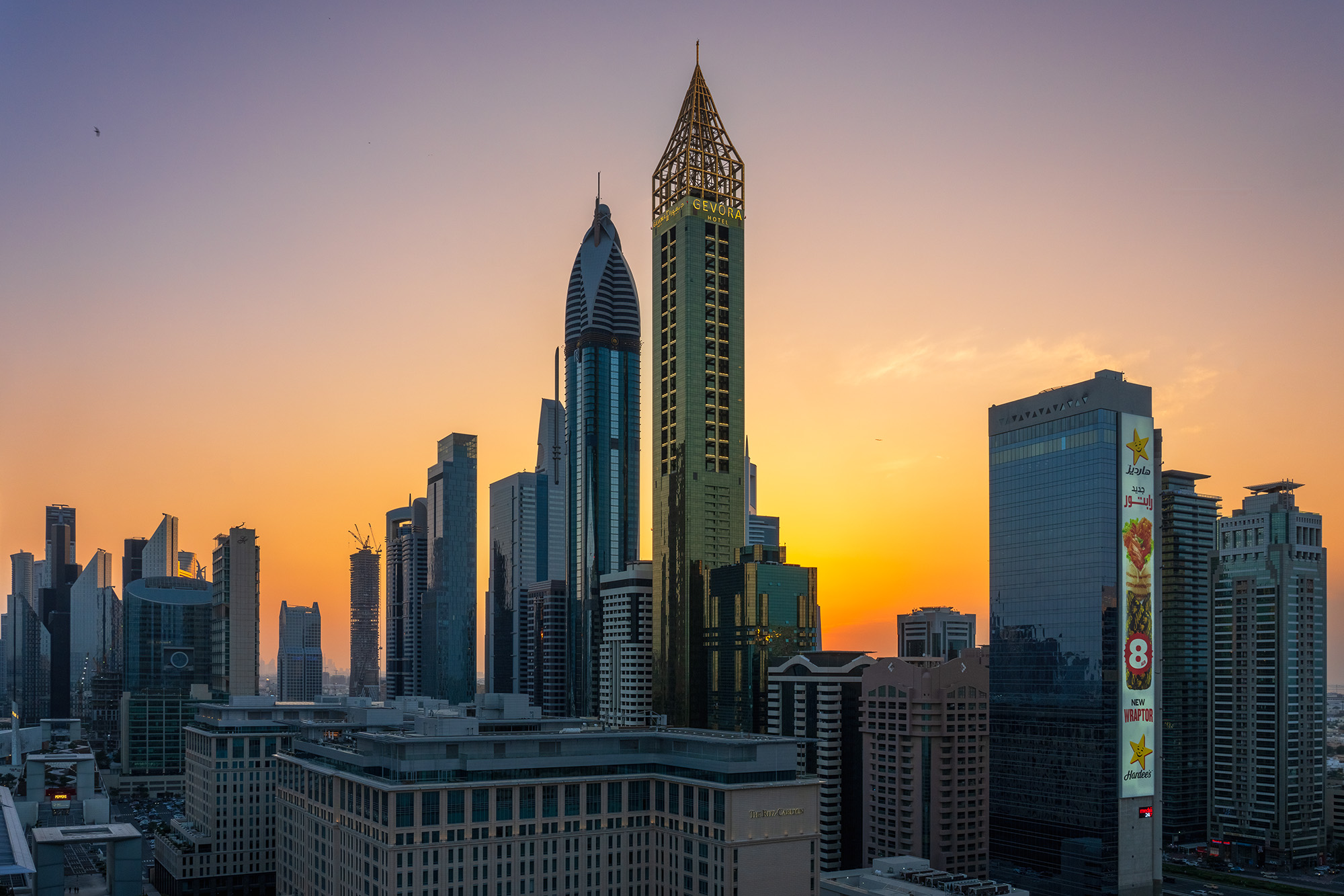 Radiant Urban Tapestry Captured at sunset, "Radiant Urban Tapestry" unveils a striking vista along Sheikh Zayed Road. The skyline is a symphony of architectural...