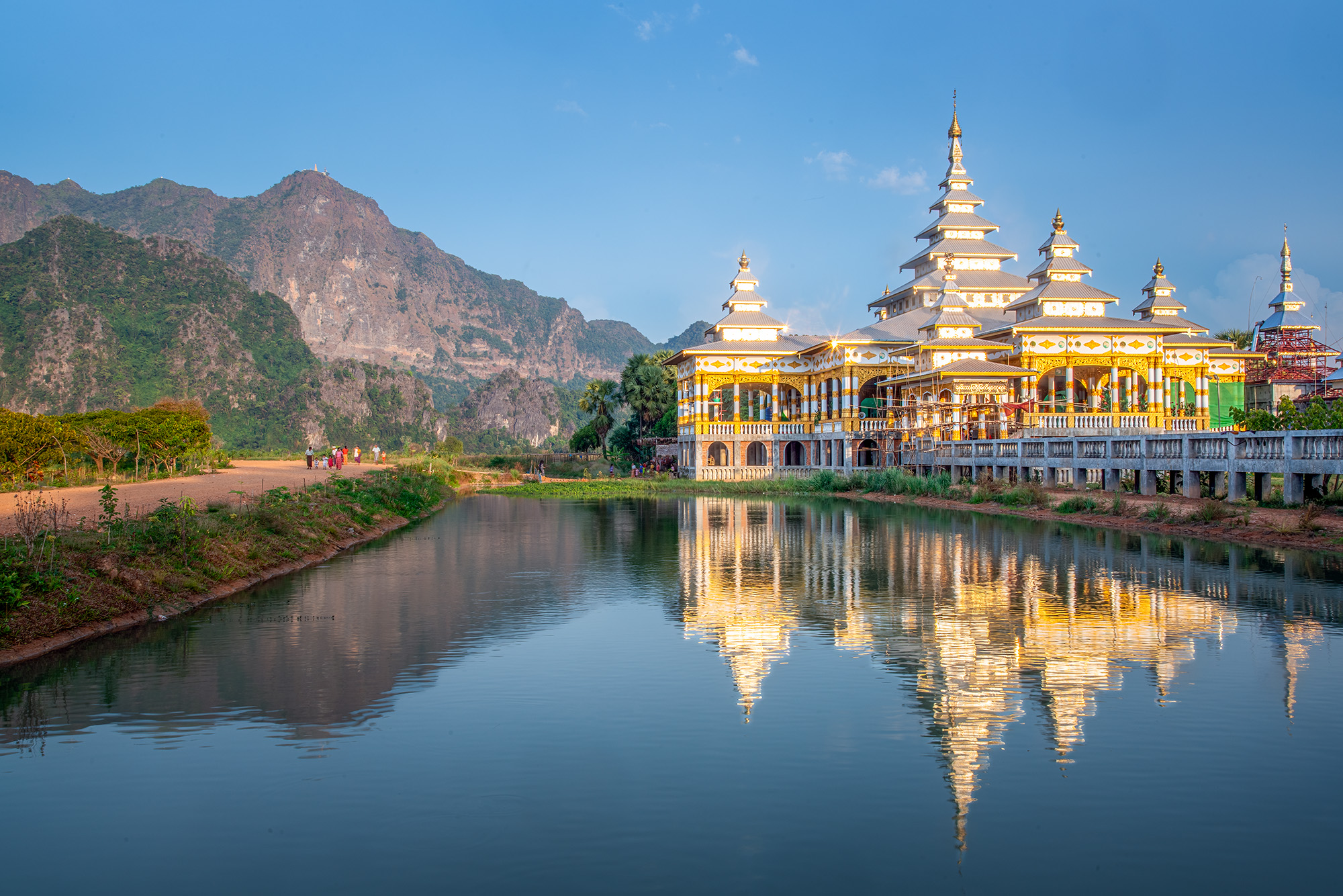 Harmony of Reflections "Harmony of Reflections" is a captivating image captured at the Kyauk Ka Lat Pagoda in Myanmar. The pagoda, bathed in serene...