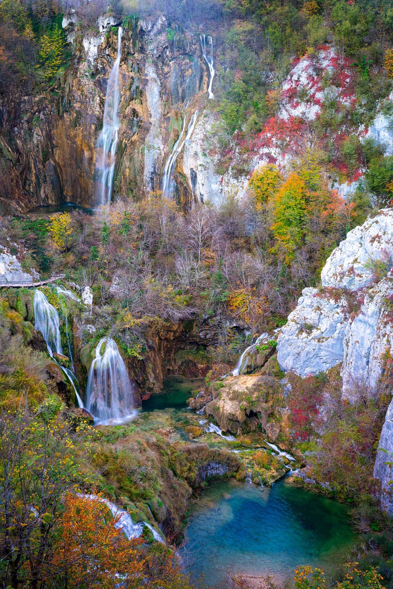 "Autumn's Cascade Canvas" presents a vertical snapshot from the vibrant fall season in Plitvice National Park, Croatia. Nature...