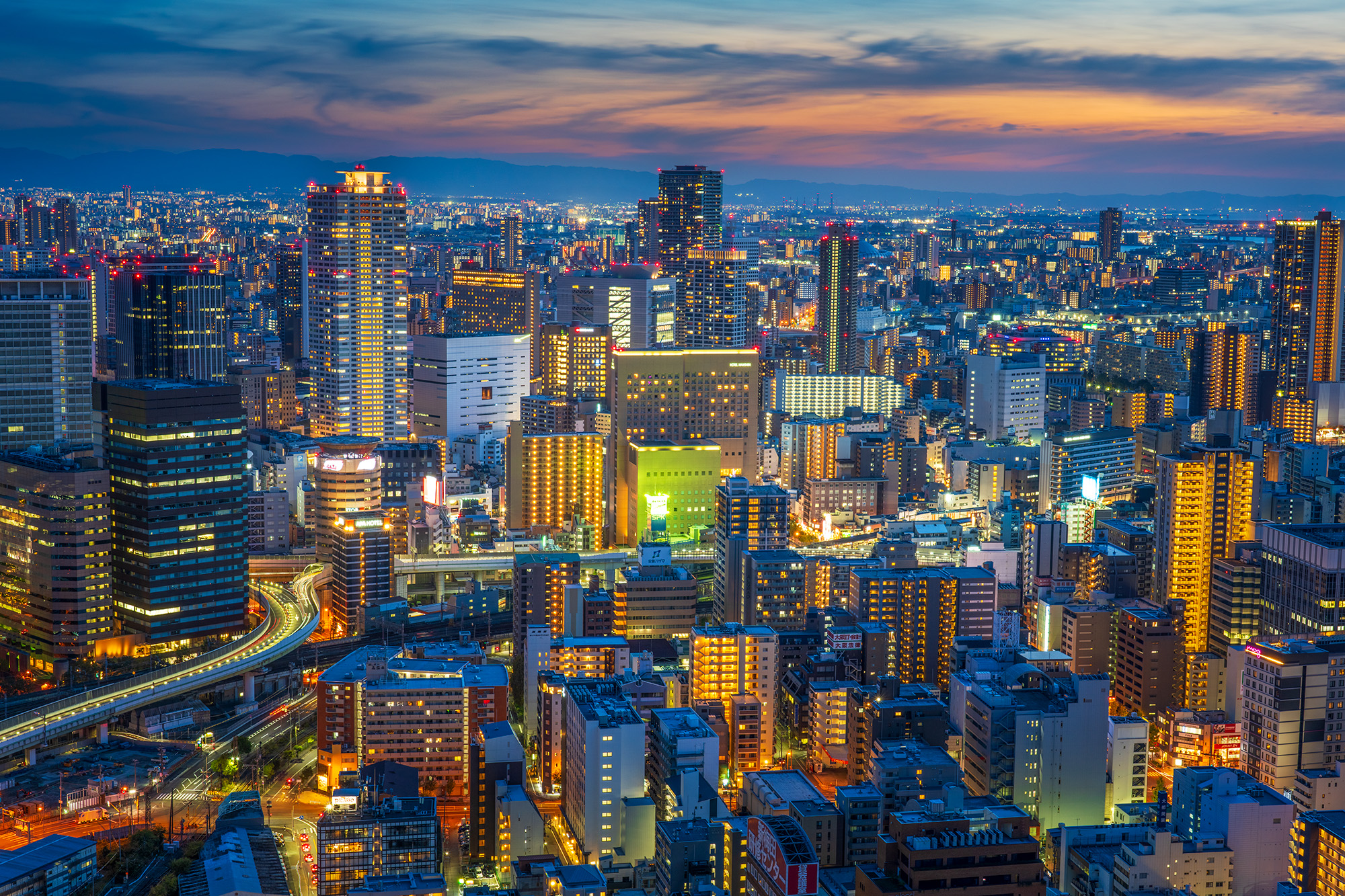Captured from the Umeda Sky Building rooftop during the mesmerizing blue hour, this image showcases Osaka's modern skyline in...