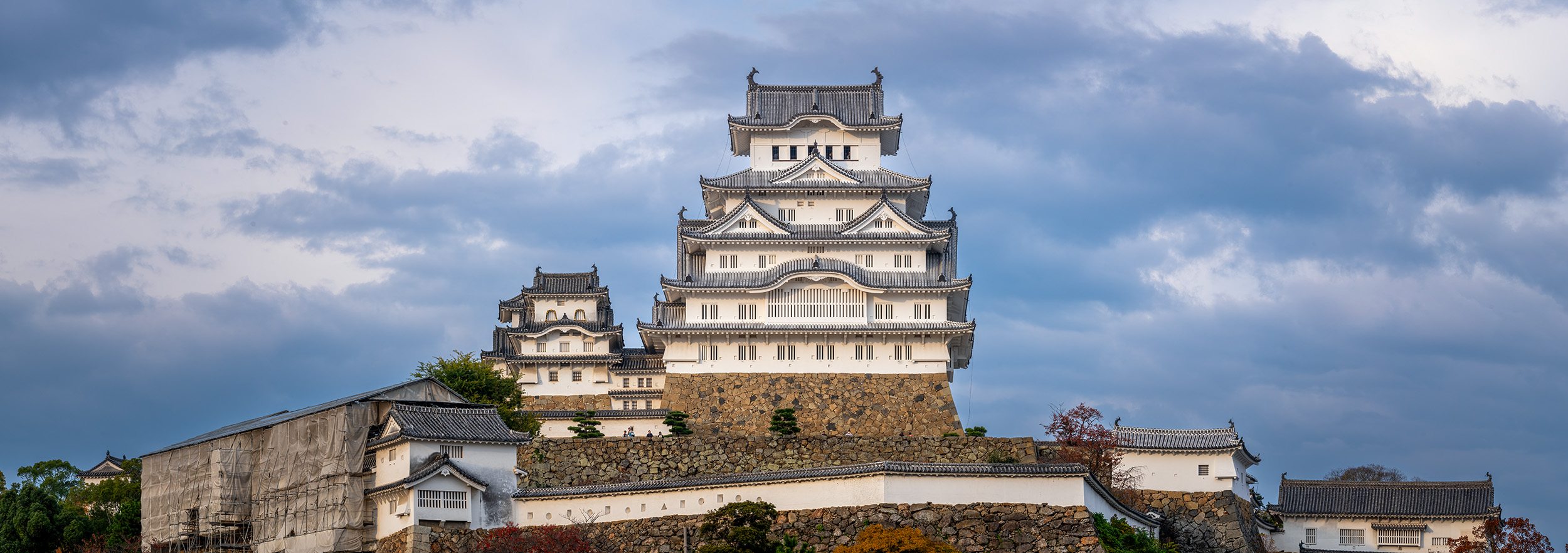 Majestic Himeji Castle Panorama Himeji Castle, a pristine white jewel of Japanese architecture, stands proudly against the backdrop of brooding clouds. In this...