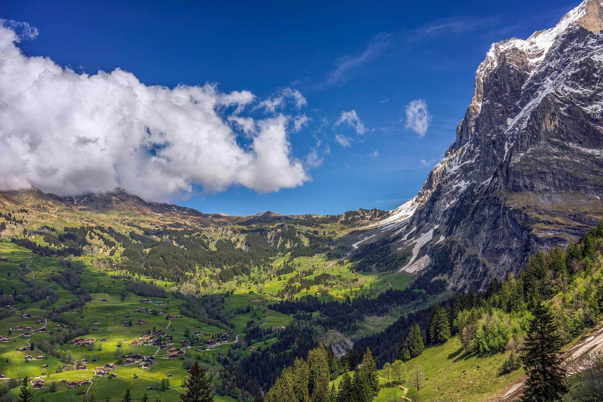 "Grindelwald's Alpine Splendor" captures the essence of a picturesque Swiss valley. In this scene, the valley unfolds beneath...