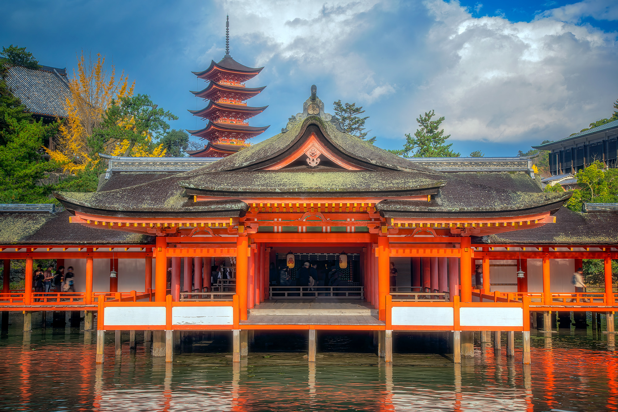This image captures the beauty of the Itsukushima Jinja Honden Shrine in Miyajima, Japan. The shrine stands proudly on the waterfront...