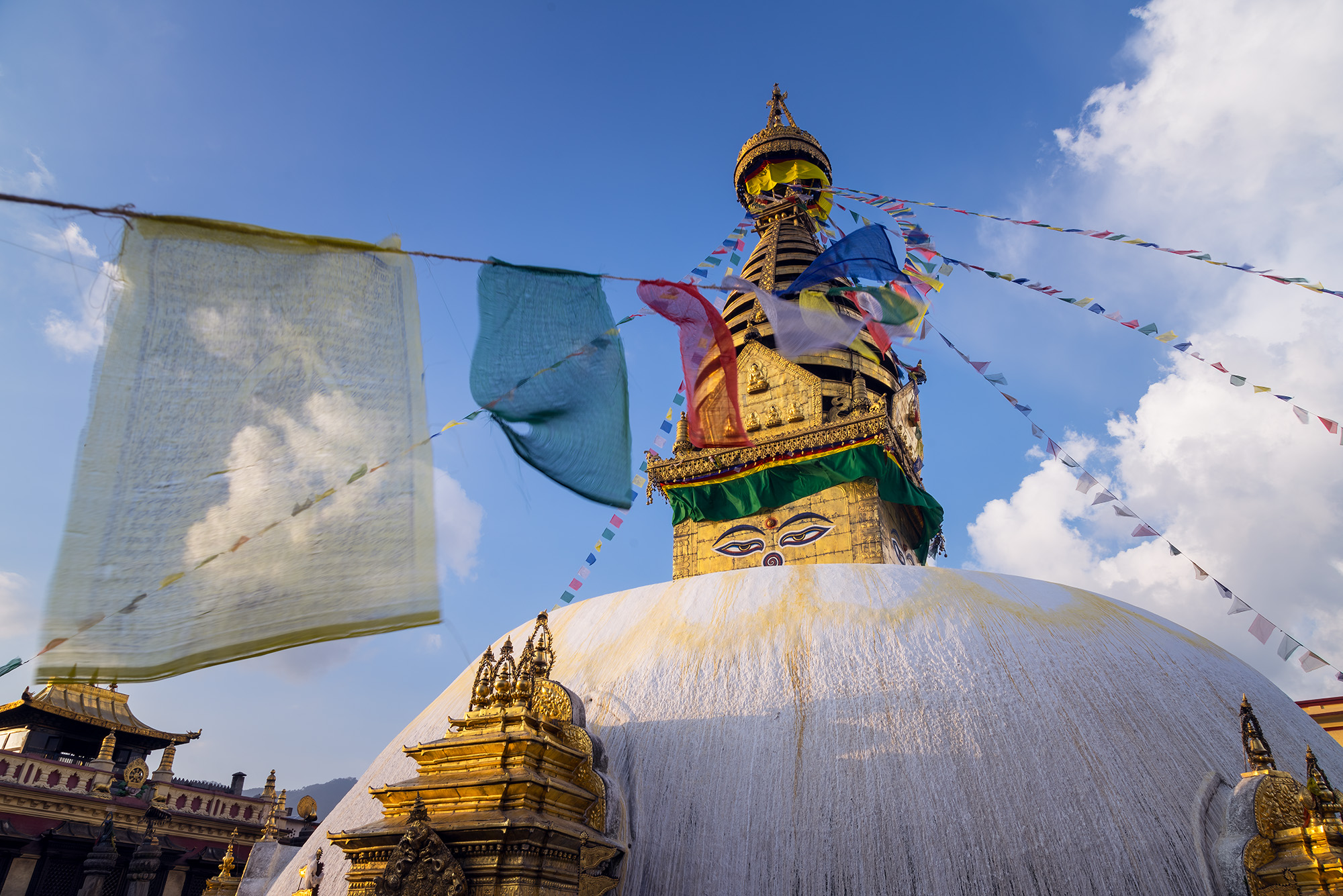 "Eyes of Devotion" offers a close-up view of Kathmandu's Monkey Temple during the early morning. A prayer flag takes center stage...