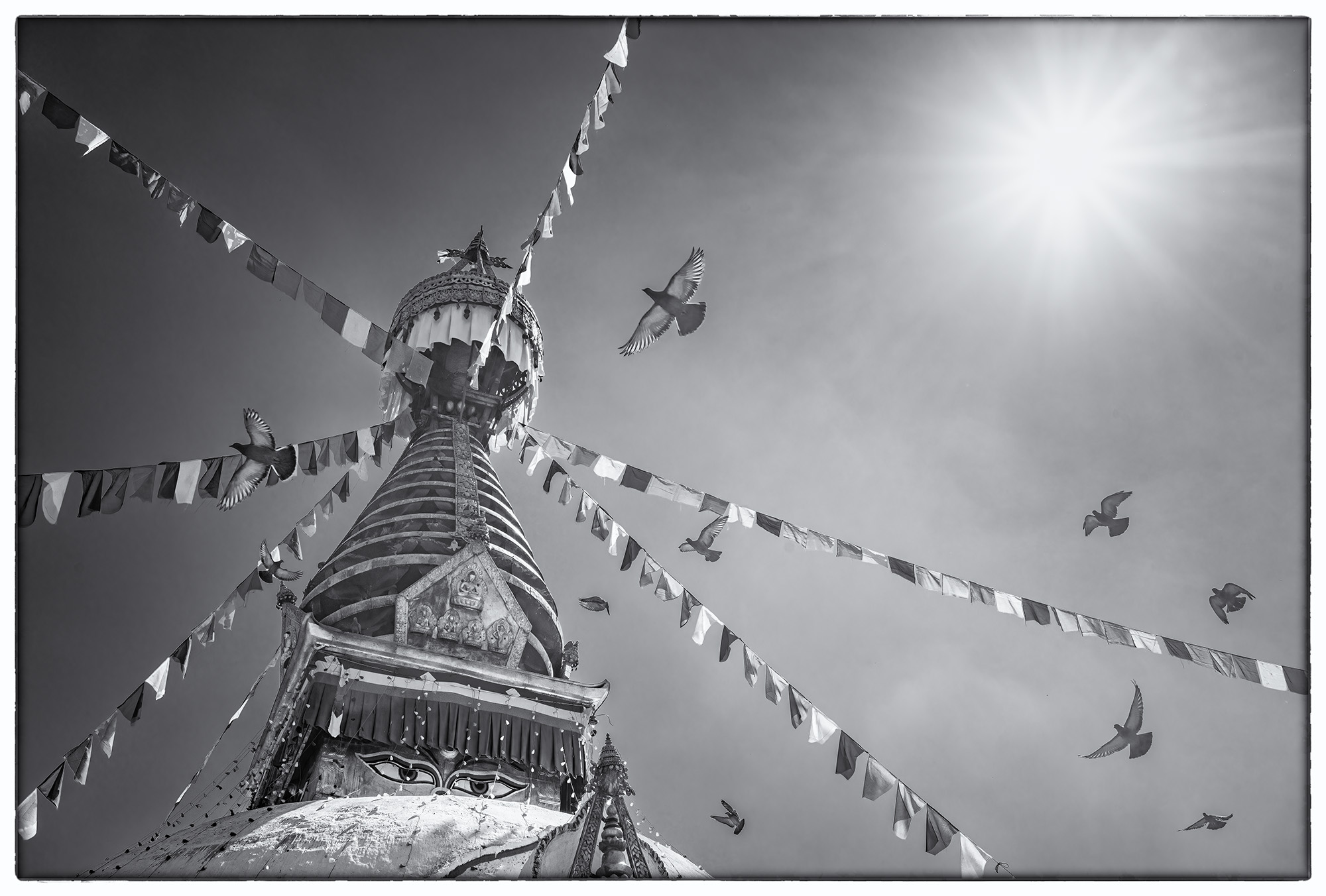 "Skyward Devotion" captures a profound moment at the Kirti Nihar Temple in Kathmandu, Nepal. The majestic main stupa stands tall...