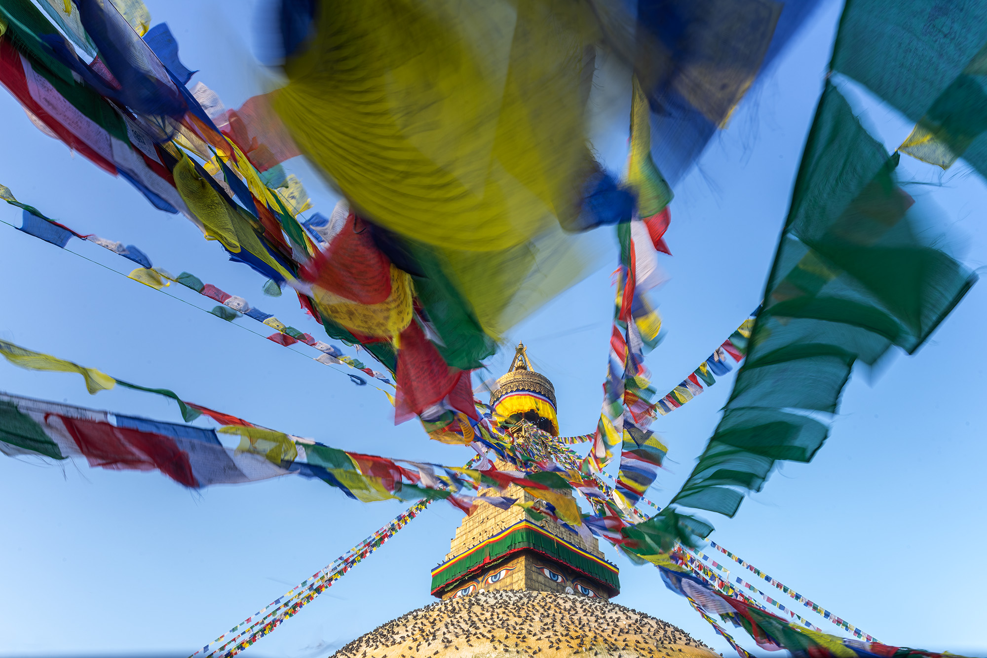 "Ascending Blessings" offers a unique perspective of Boudhanath Stupa in Kathmandu, Nepal. As dawn's first light bathes the stupa...
