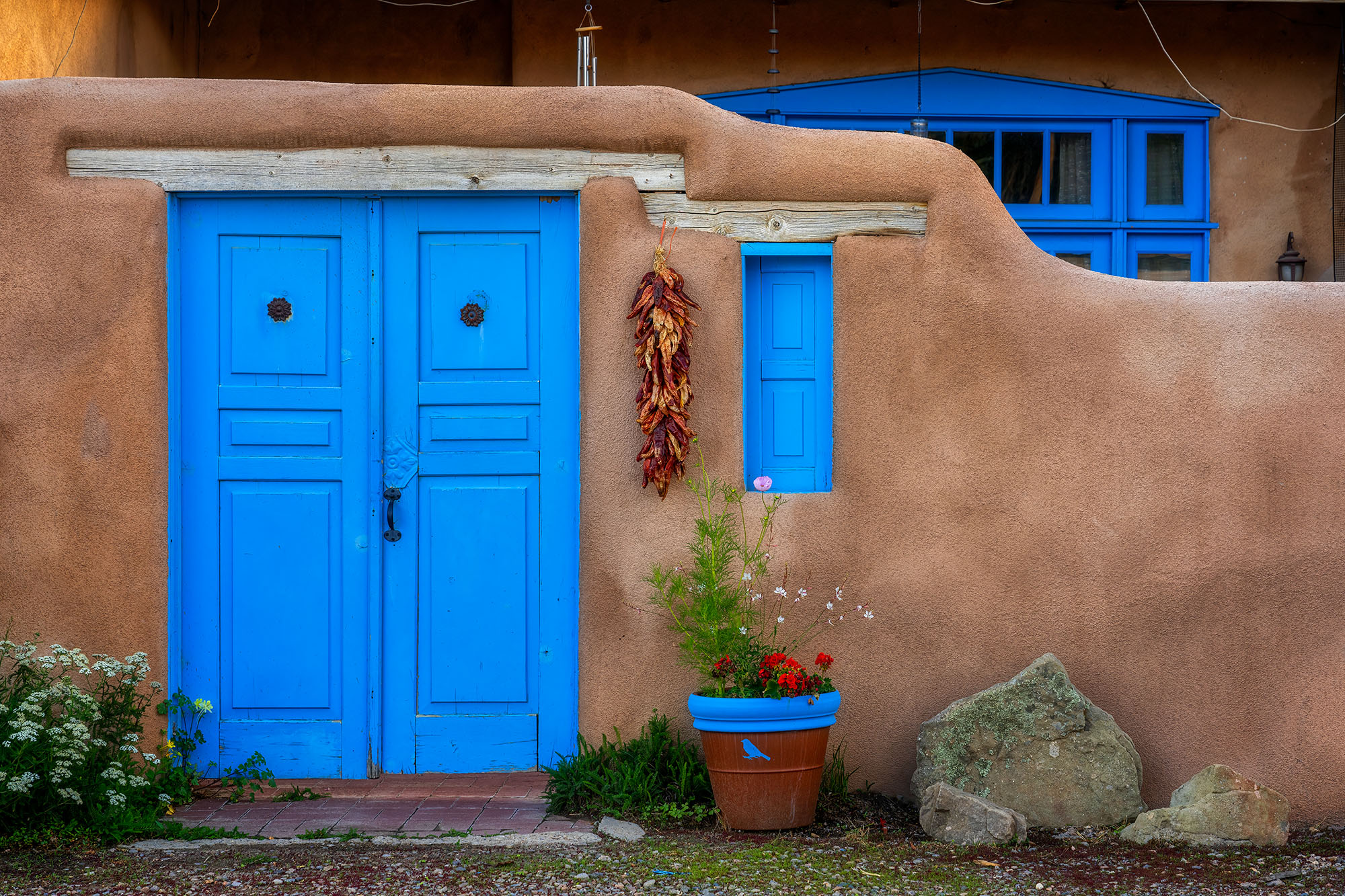 Nestled in the heart of Taos, New Mexico, "Adobe Blues" offers a glimpse into the traditional architecture of the region. A classic...