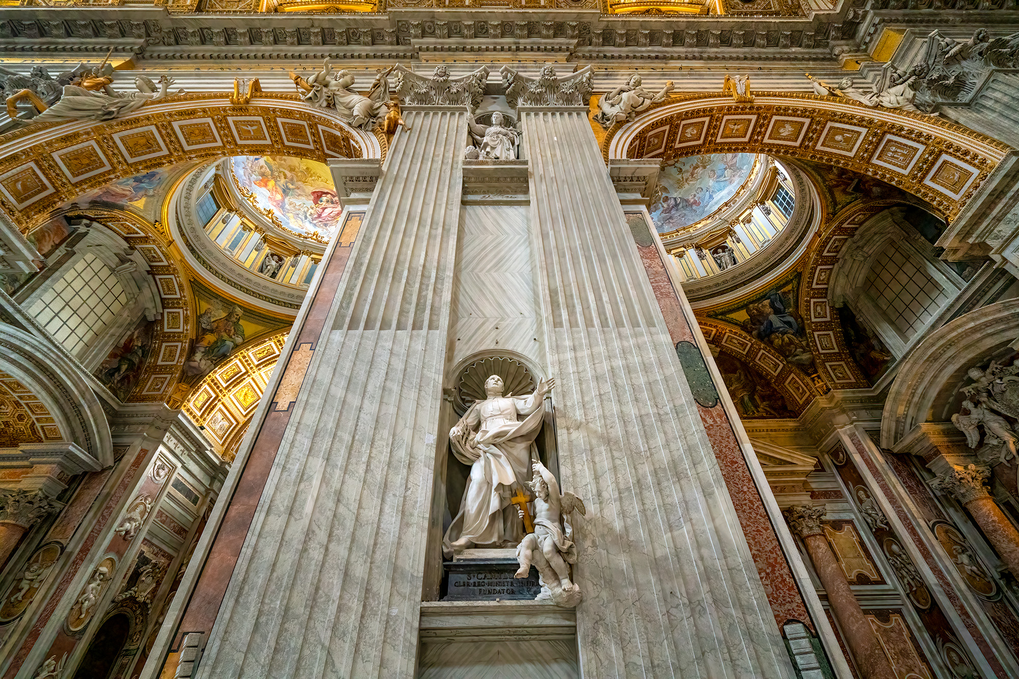 The photograph showcases the Statue of Saint Camillus de Lellis inside the Vatican, a testament to its grandeur and historical...