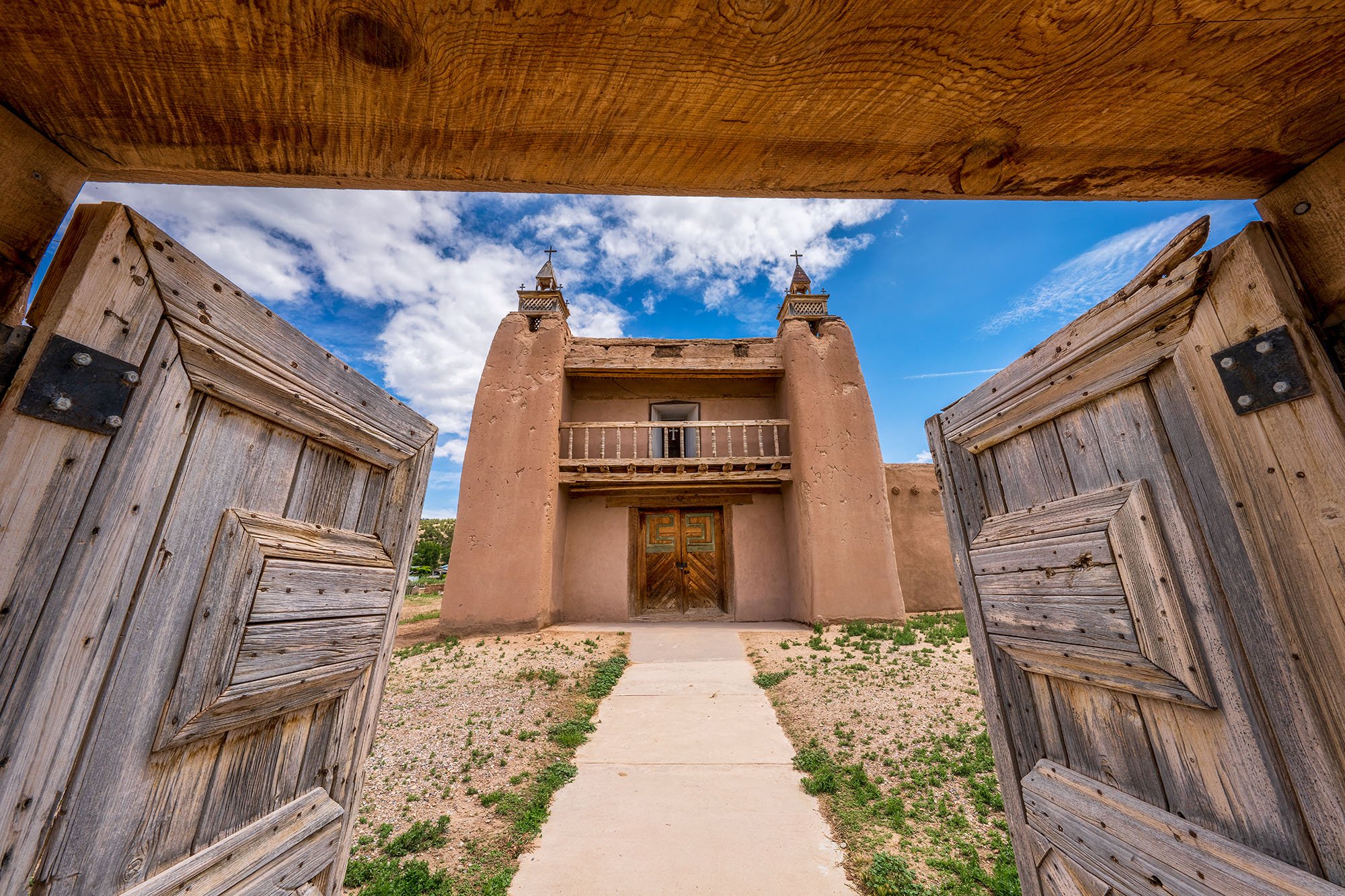 This image, captured in Las Trampas, New Mexico, features the striking San Jose de Gracia Mission Church. The photograph highlights...