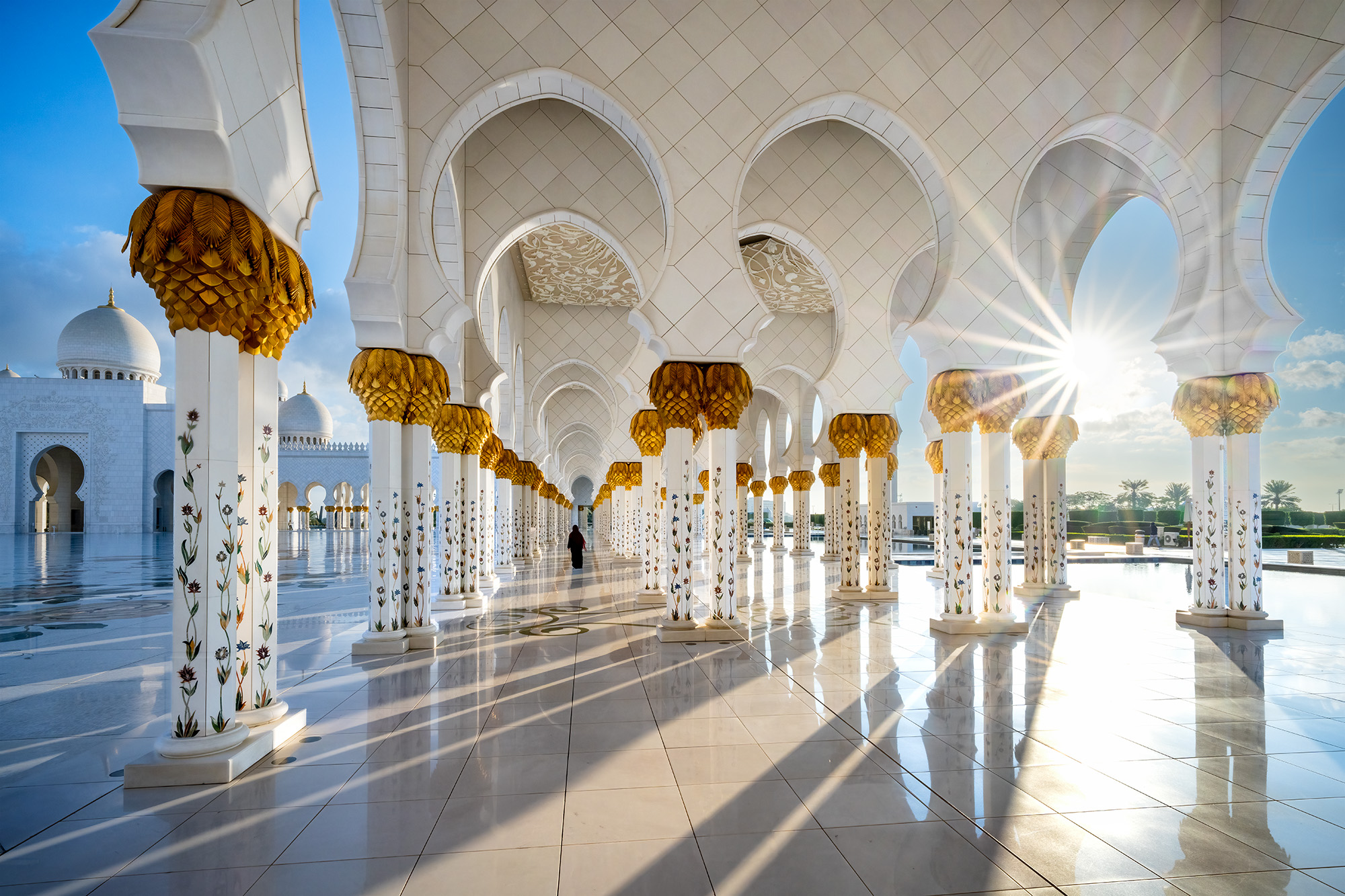 In the heart of the Sheikh Zayed White Mosque, "Illuminated Passage" is born from a moment of serendipity. A woman's elegant...