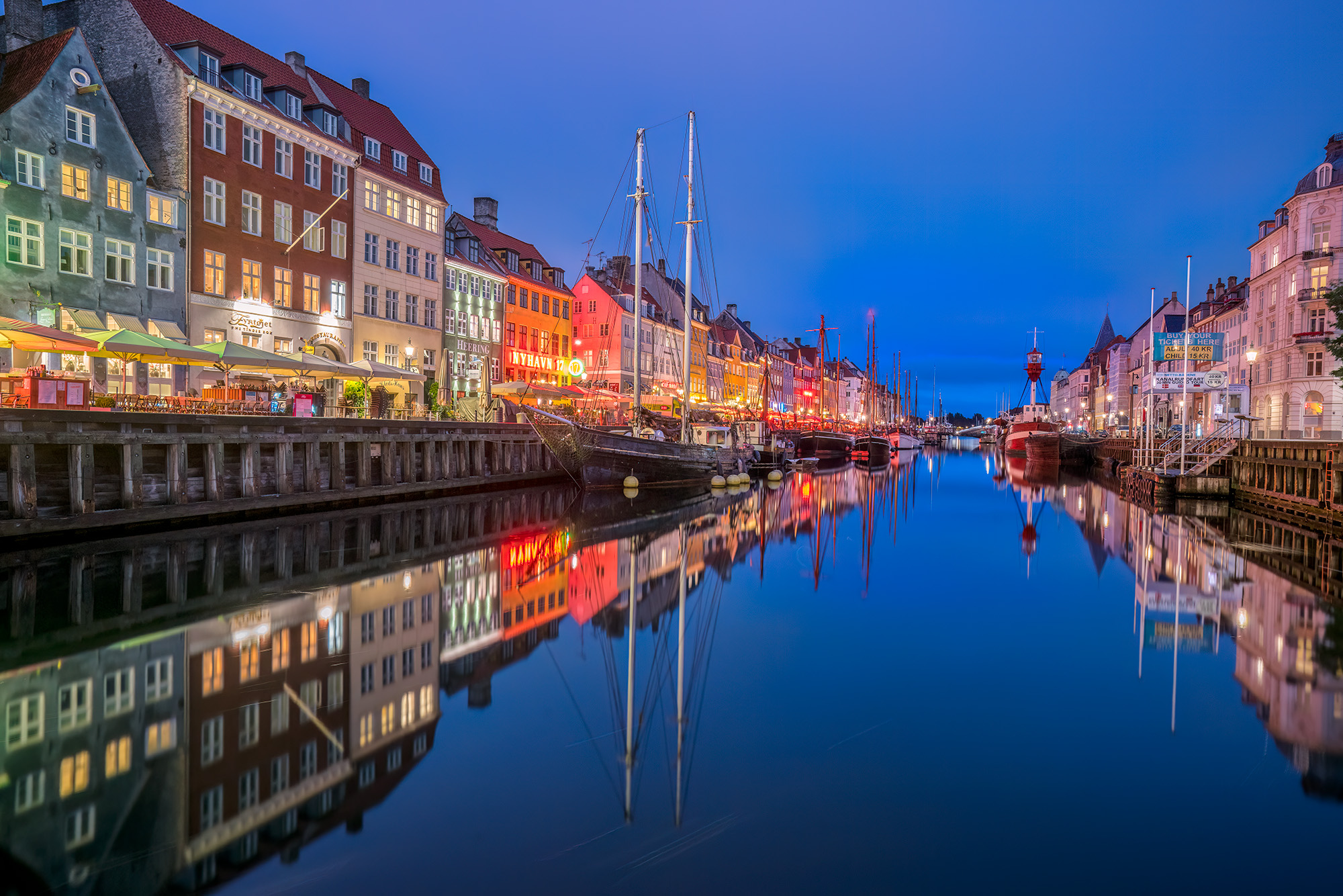 During blue hour in the Nyhavn area of Copenhagen, Denmark, I was captivated by the vibrant display of colors and reflections...