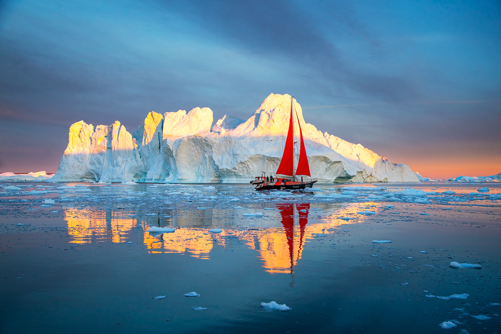 Among my all-time favorite images, this shot captures an iceberg reflecting in Disko Bay, accompanied by a graceful sailboat...