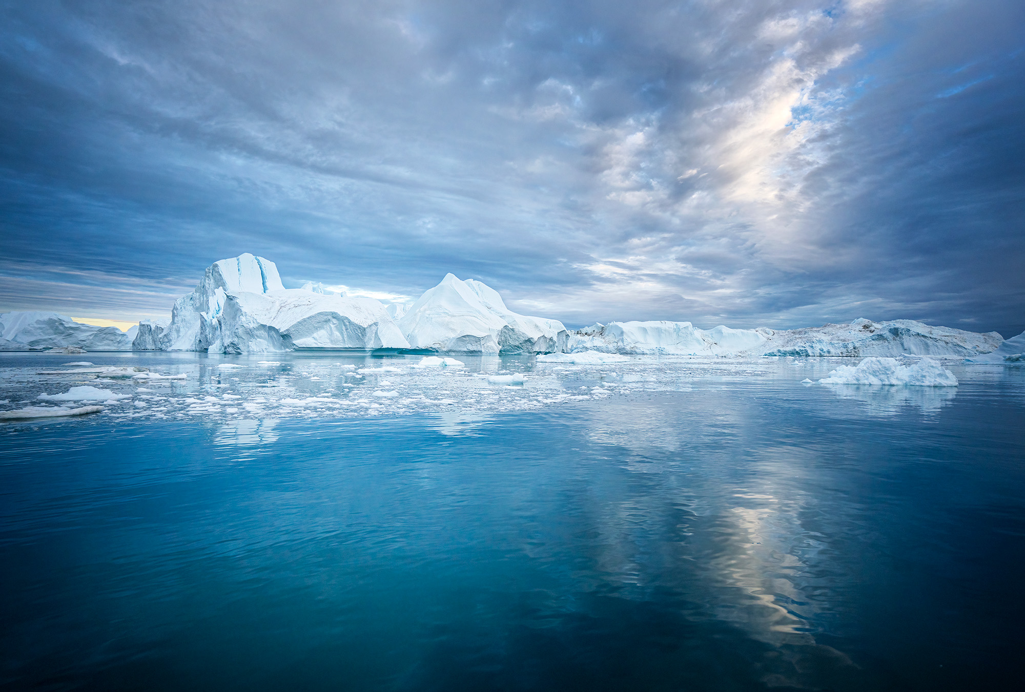 "Arctic Mirrors" is a captivating portrayal of Disko Bay, near Illulisat, Greenland. Splitting the frame, a majestic iceberg...