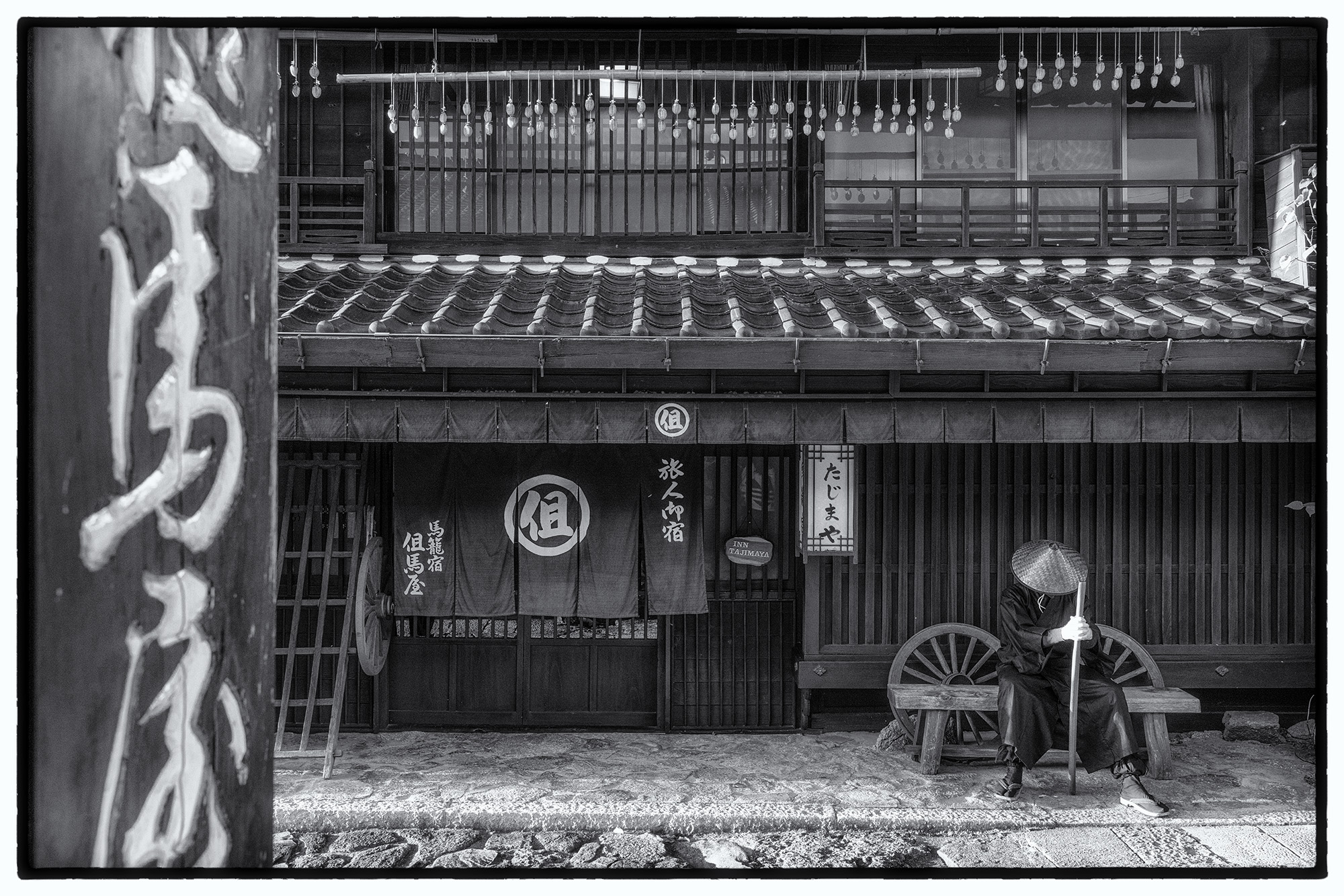 In "Silent Vigil," a lone ninja takes respite amidst the timeless charm of a traditional Japanese town. Clad in shadowy attire...