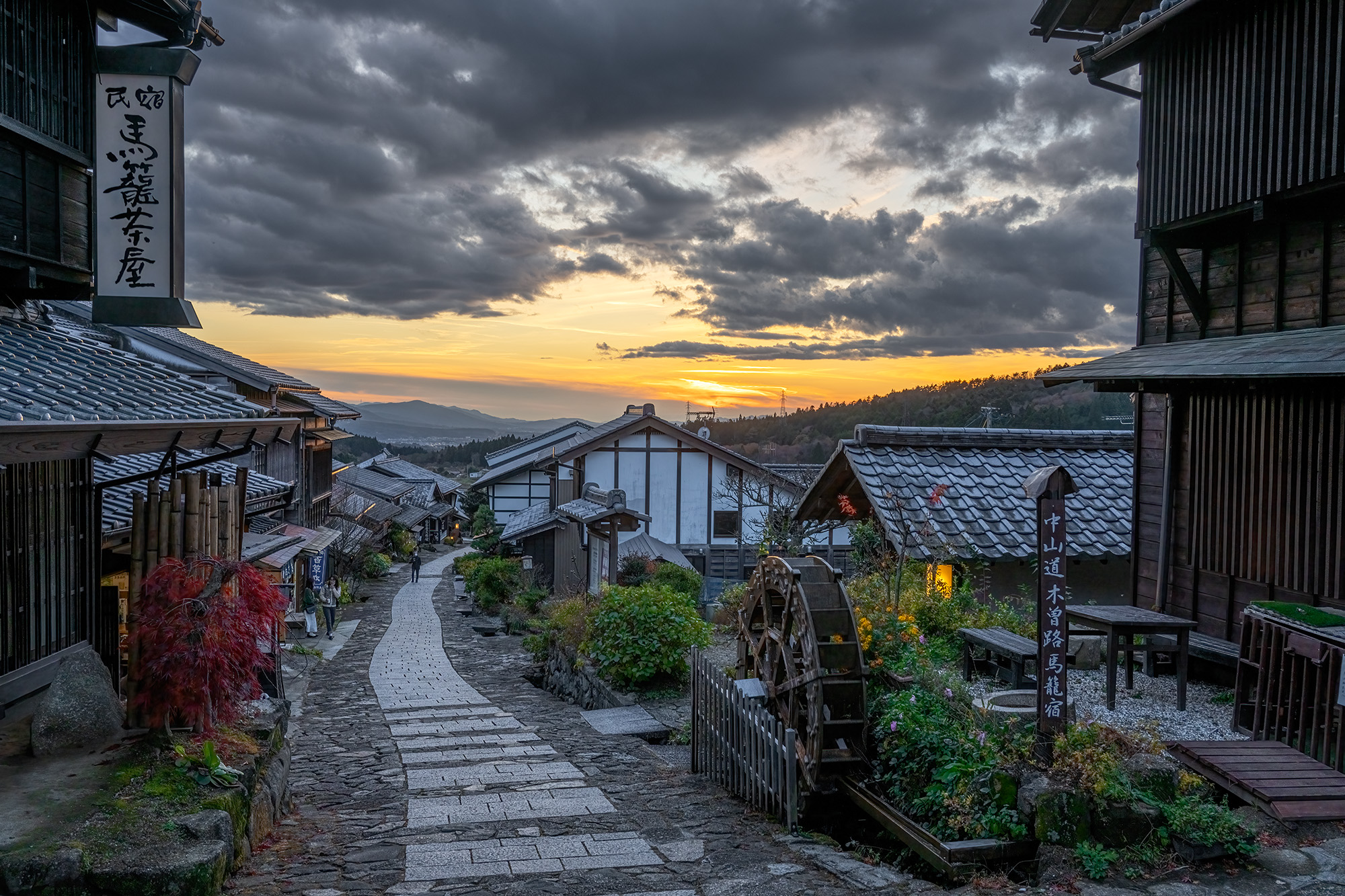 Path to Sunset Dreams" captures the captivating scene in Magome, Japan. The path, flanked by traditional buildings, stretches...