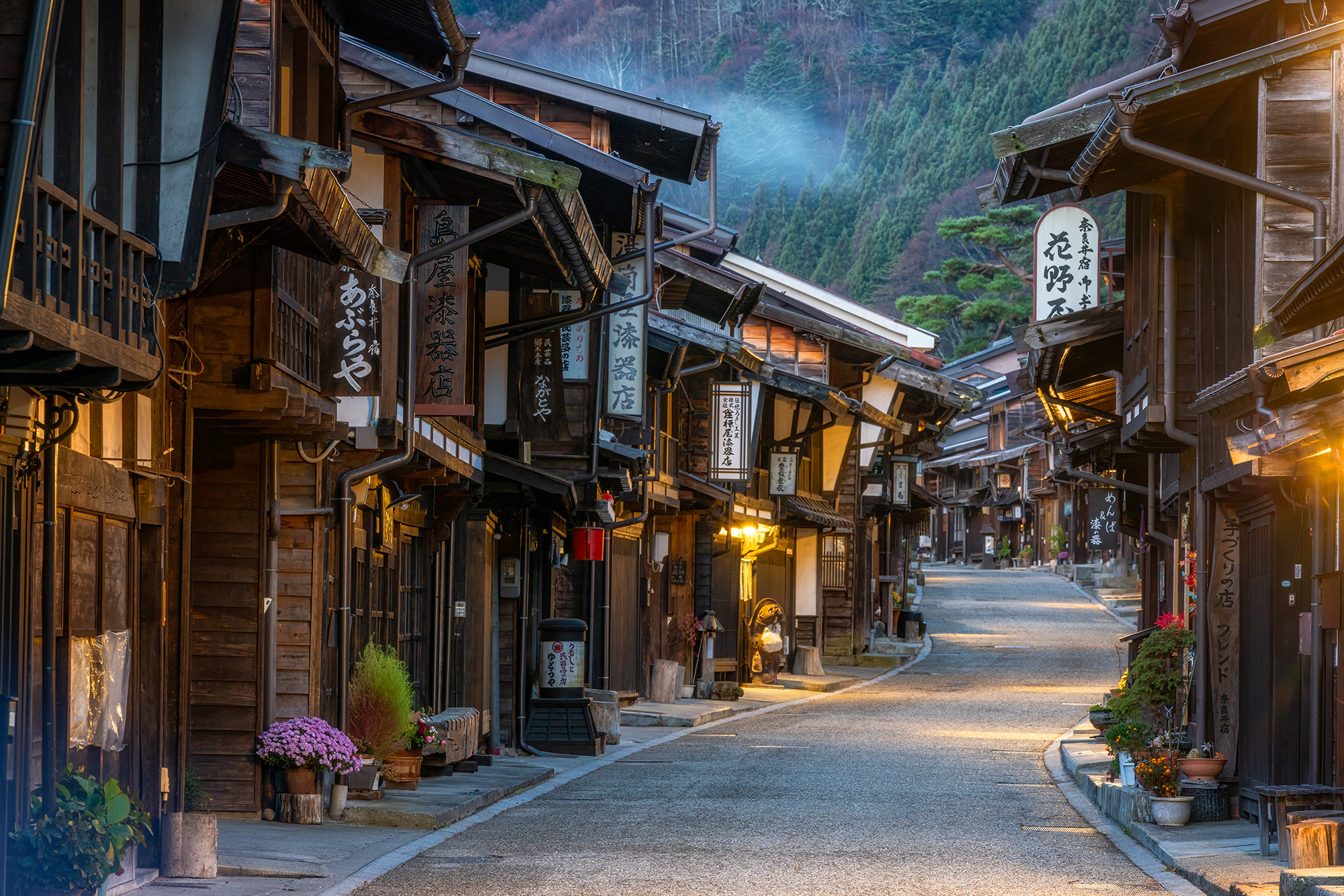 "Dawn in Edo's Embrace" captures the enchantment of Tsumago-juku, Japan, in the early pre-sunrise hours. The town exudes an Edo...