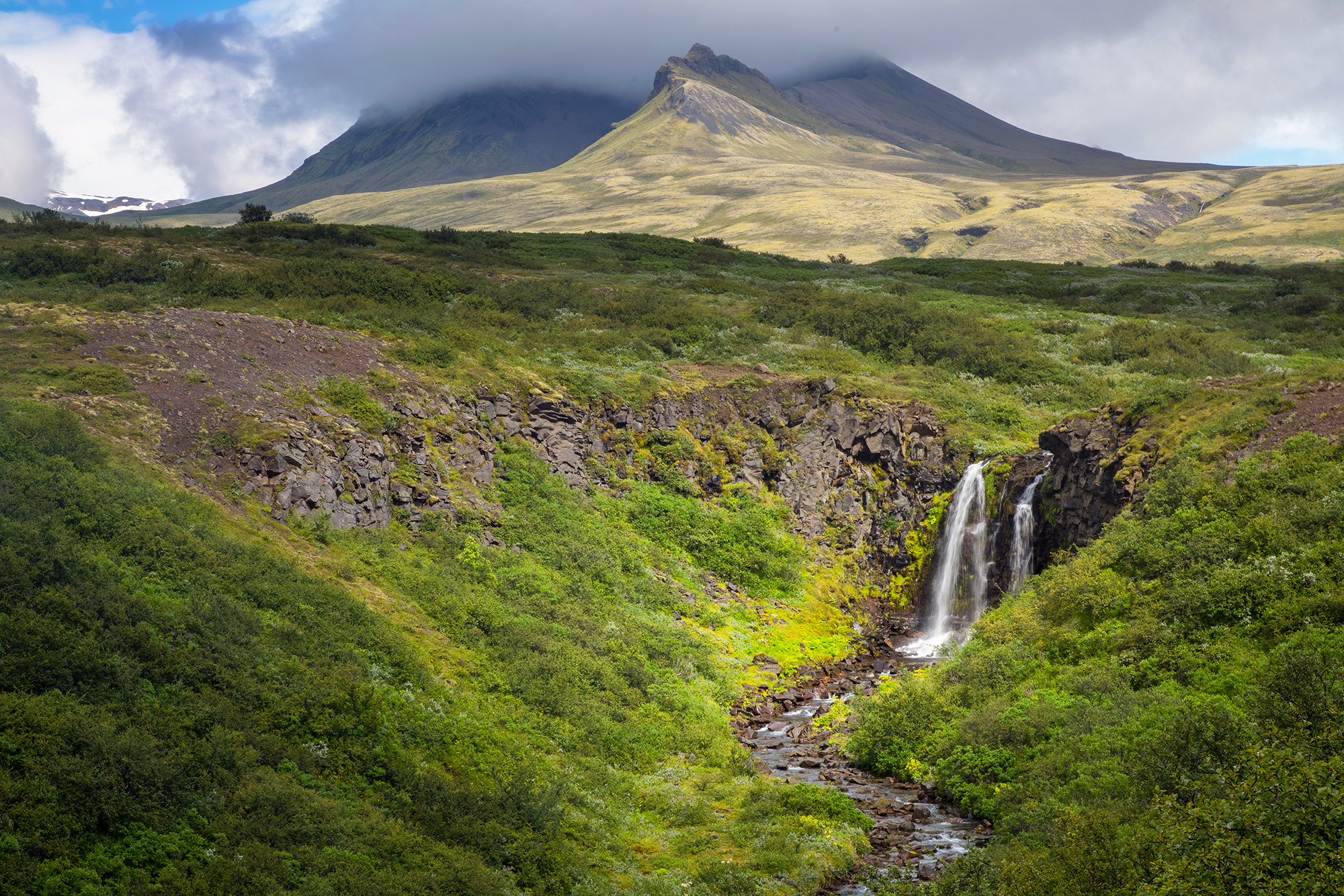 Nature's Spotlight on Svartifoss This image was captured at Svartifoss in Iceland. It portrays a waterfall basking in a radiant spotlight of sunlight, nestled...