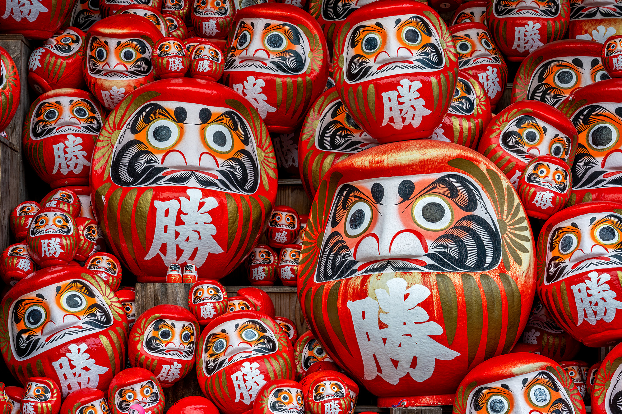 Daruma Gathering A mesmerizing display of many Daruma dolls in assorted sizes forms the heart of the Katsuo-ji Temple in Japan. These iconic red...