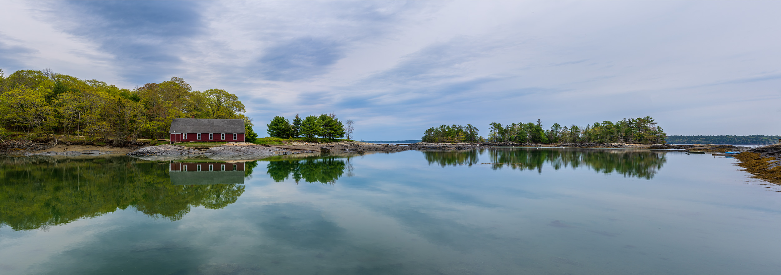 "Canary Cove Reflections" presents a captivating panorama of the serene Canary Cove in Blue Hill, Maine. The image beautifully...