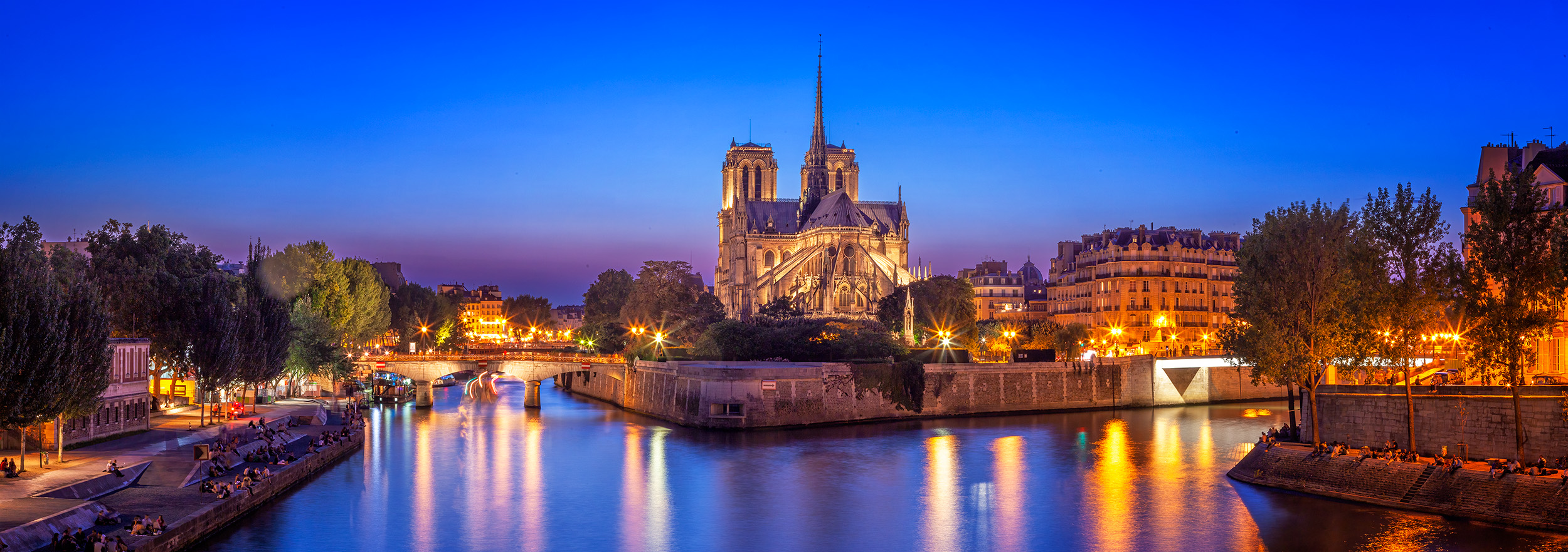 Notre Dame Reflections "Notre Dame Reflections" is a panoramic image captured during the enchanting blue hour in Paris, France. The majestic Notre Dame...