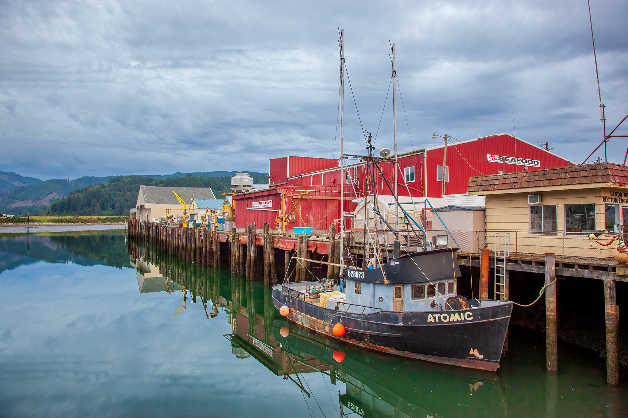Fishing Harbor This image captures Garibaldi's fishing harbor in Oregon. The waters lie perfectly still, mirroring the scene above, where a...