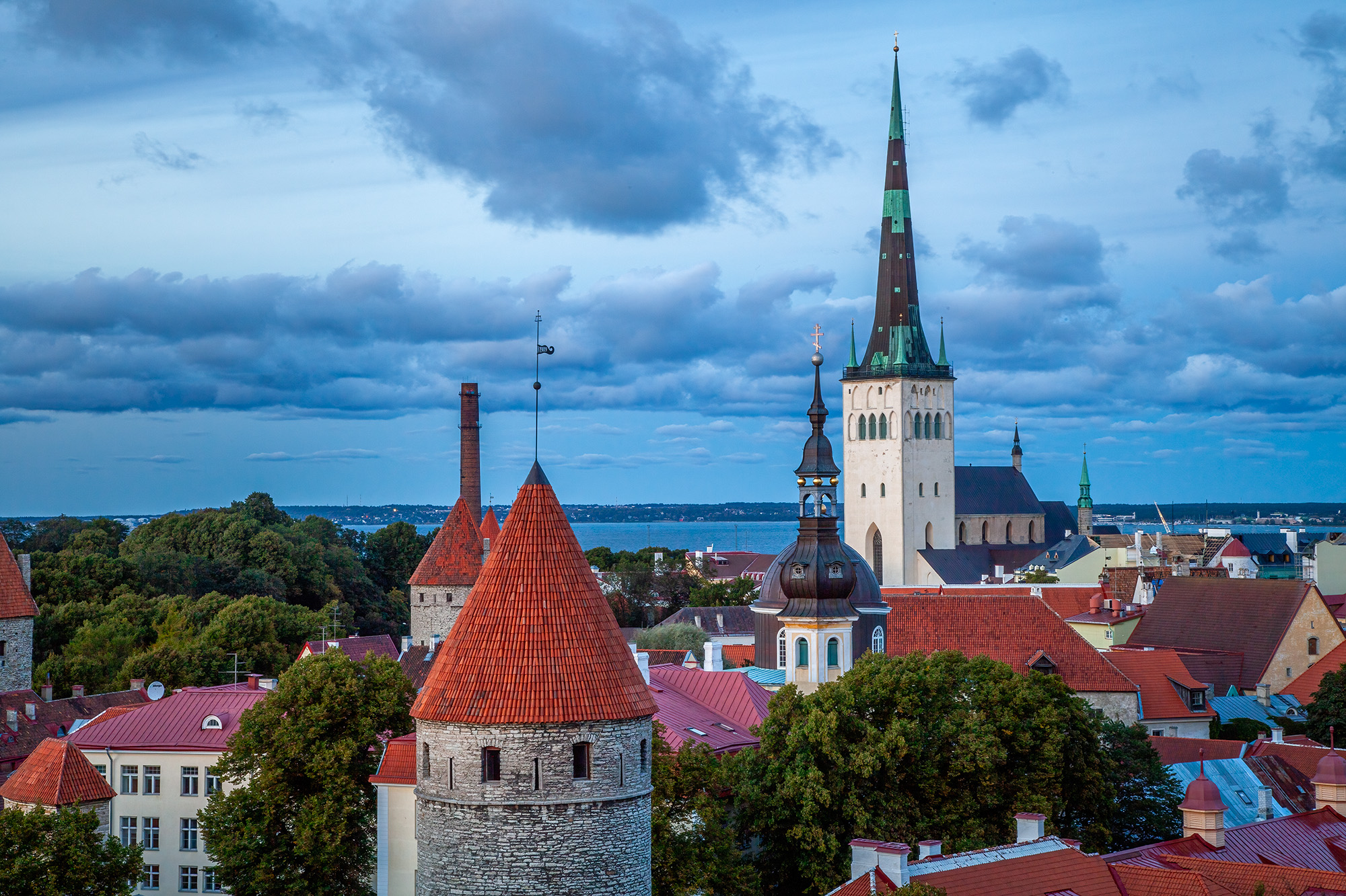 This evening shot captures the rooftops of Tallinn, Estonia's historic town. The cityscape is adorned with prominent landmarks...