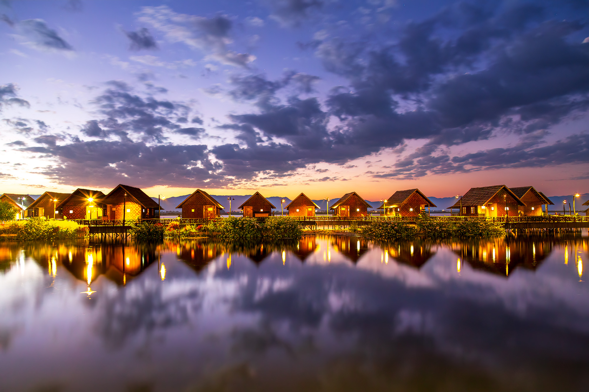 Beneath the vast expanse of a radiant sunset, "Horizon's Embrace" captures the enchanting view from the "Sky Lake Inle Resort...