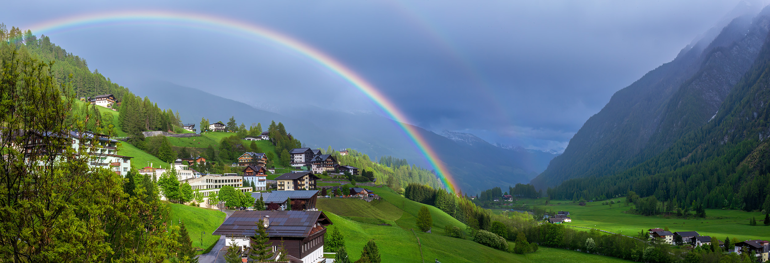 Rainbow Over Heiligenblut Nestled high in the mountainous embrace of Heiligenblut, this panoramic view captures the essence of springtime's renewal. The...