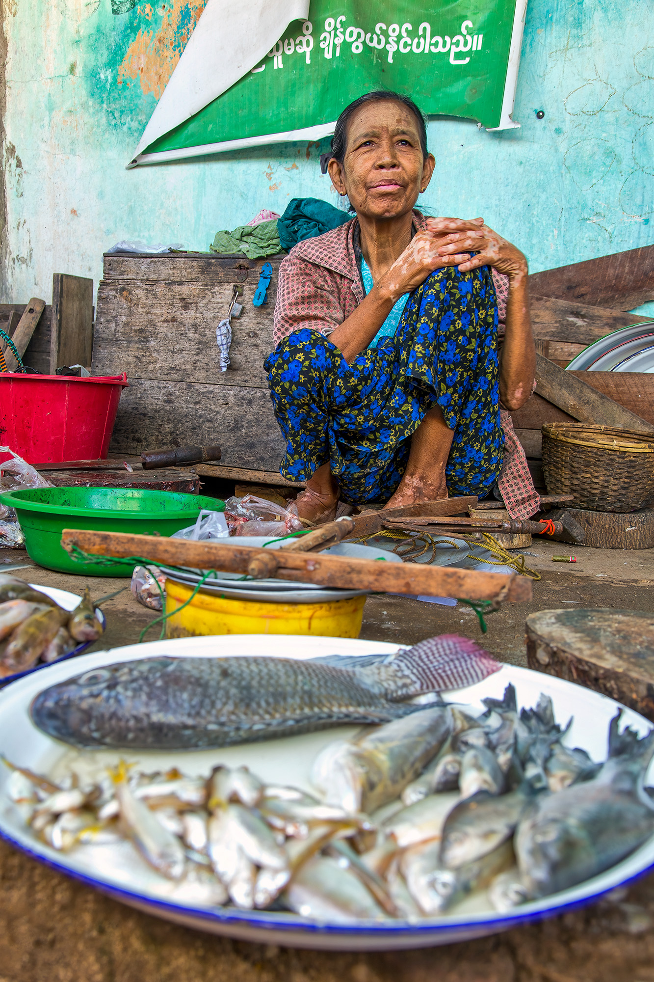 In the bustling market of Tettaung, Shan State, Myanmar, I captured a fleeting moment of everyday life. A seated woman tends...