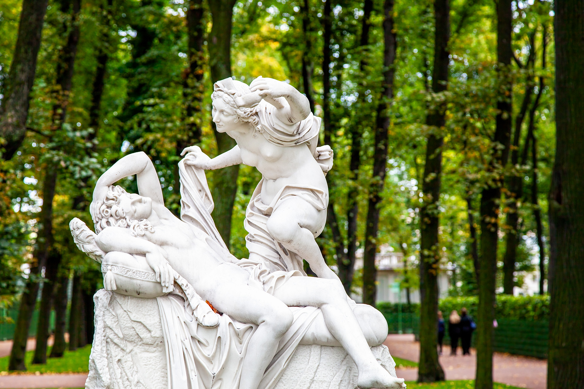 Amidst the lush greenery of St. Petersburg's Summer Garden, a late 17th-century Italian marble masterpiece, "Cupid and Psyche...