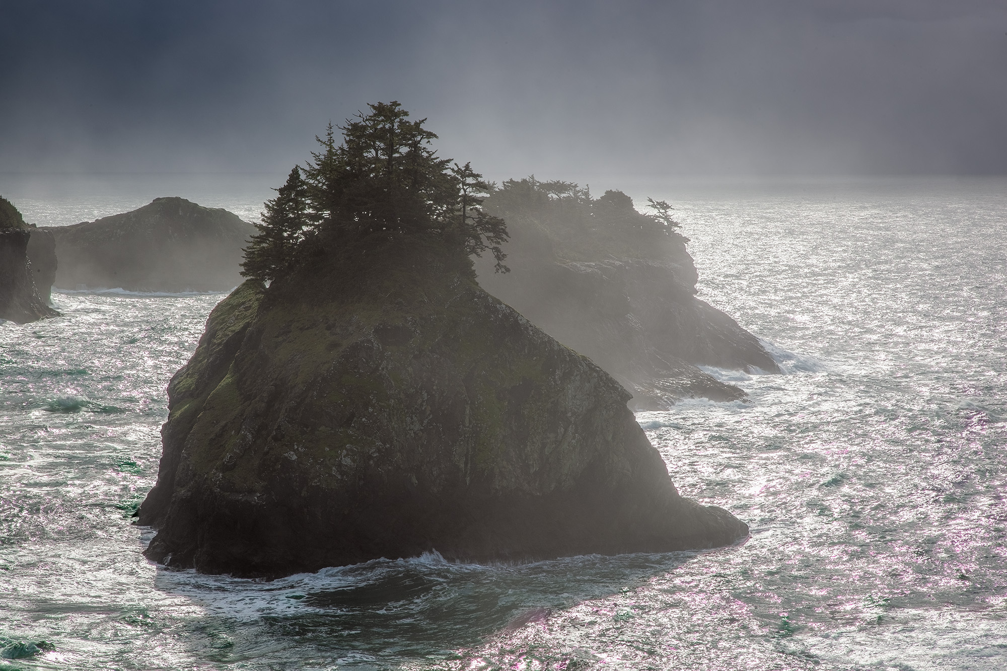 Haystack Rock Battling the Storm This striking image captures the fierce beauty of an Oregon coast icon, Haystack Rock. The rock formation stands resilient in...