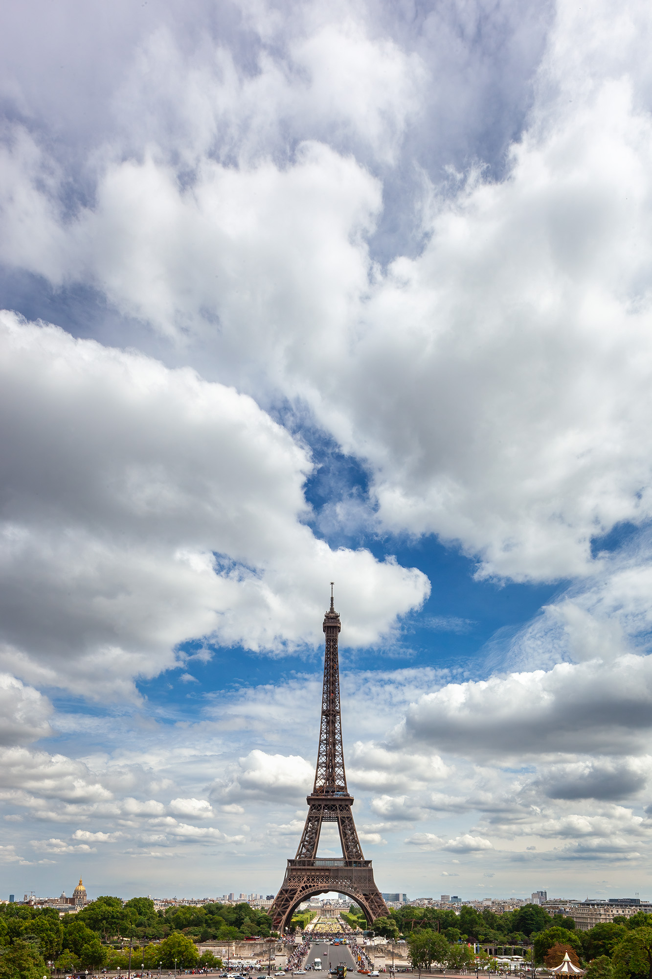 "Eiffel Tower Under Dramatic Skies" showcases the iconic Parisian landmark as if it were a toy model, nestled in the bottom third...