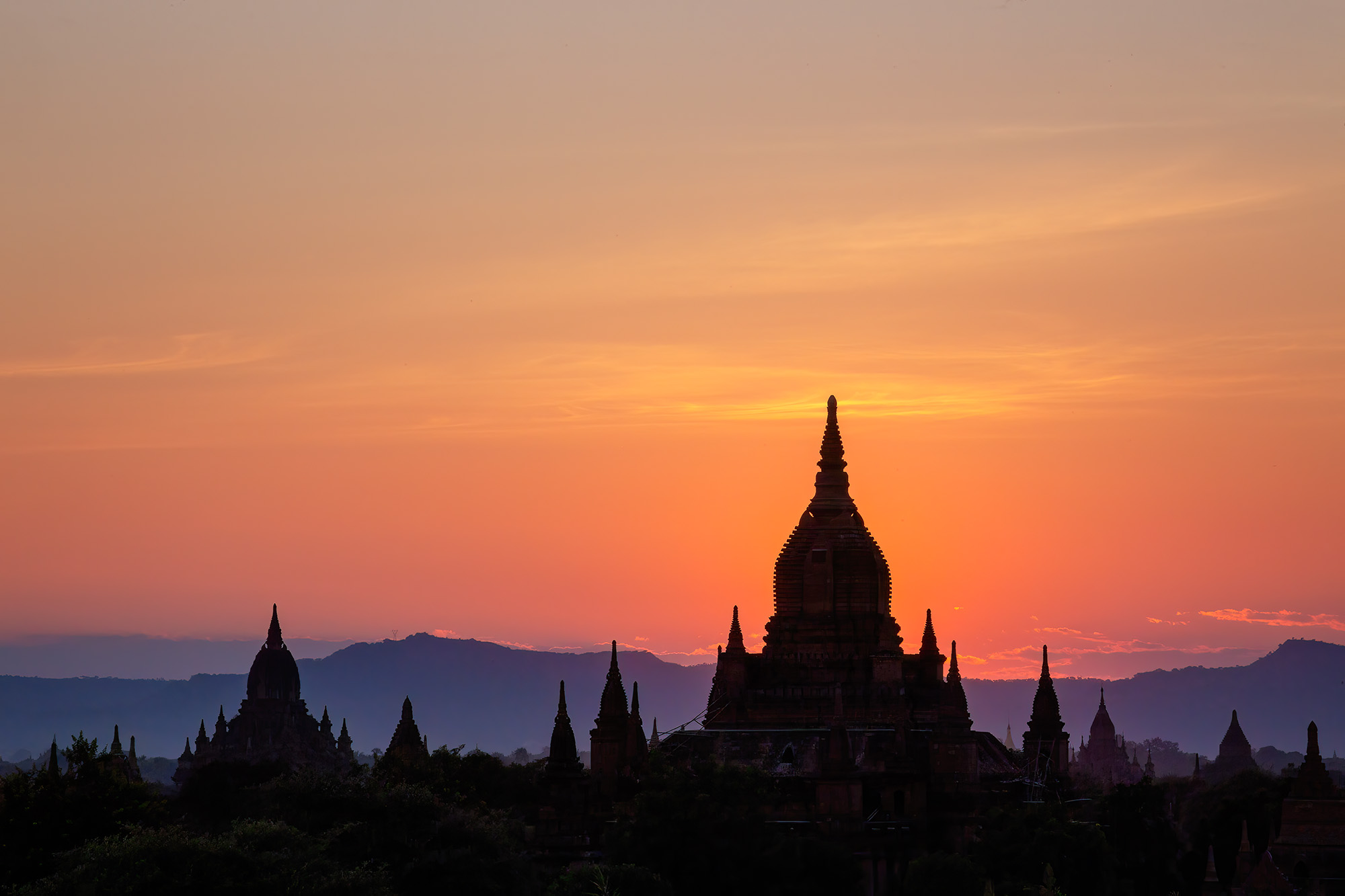 Fiery Bagan Sunset In this striking image, the silhouette of Temple #820 stands boldly against a breathtaking backdrop of a brilliant orange, red...