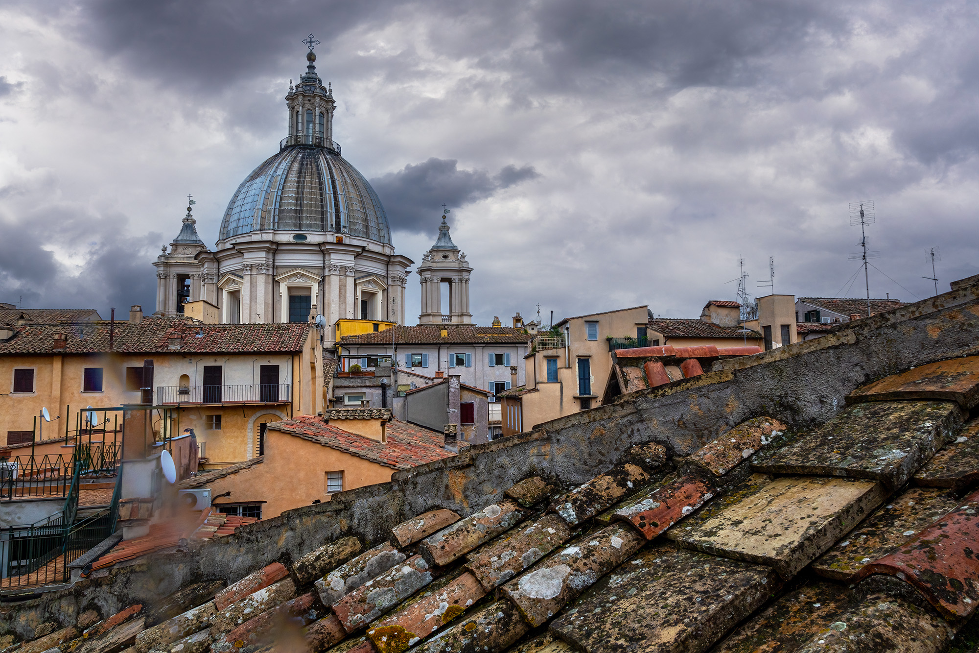 Roman Rooftops and Saint Agnese Dome From our room near the Pantheon in Rome, Italy, this image captures the essence of Roman architecture. The weathered clay-tiled...