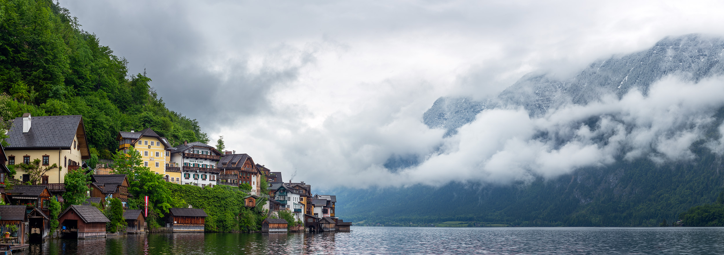 Majestic Hallstatt Horizons "Majestic Hallstatt Horizons" offers a breathtaking panorama of the enchanting village of Hallstatt, Austria. In the left third...