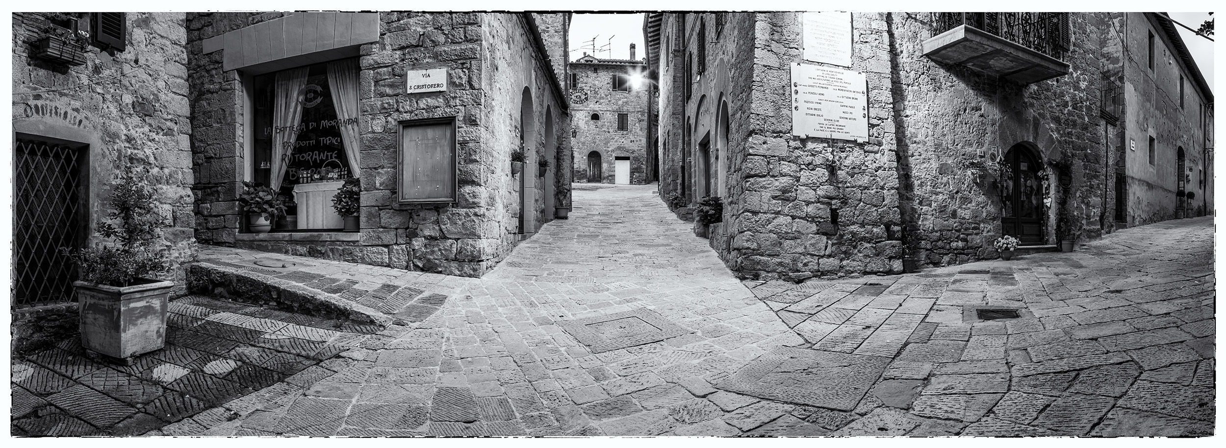 In the heart of Monticchiello, Tuscany, Italy, I captured this Black & White panoramic image, a mosaic of choices through the...