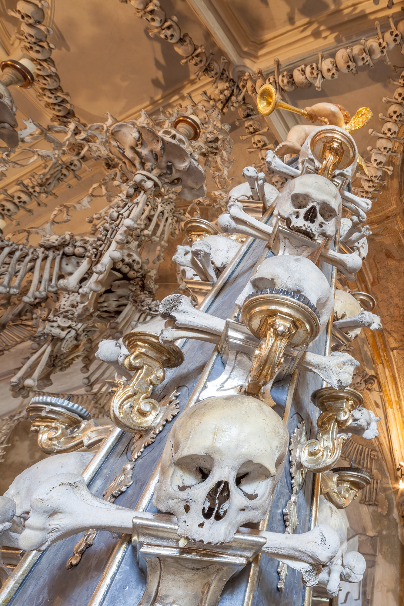 Captured within the haunting interior of Kutna Hora's bone ossuary, this image unveils a chilling sight. A tower formed from...