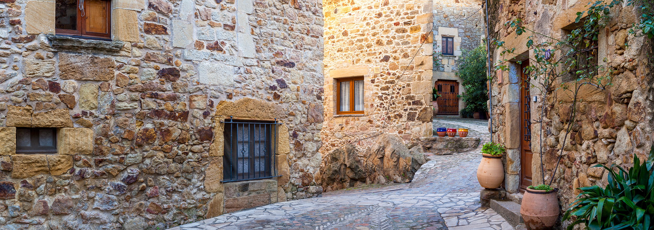 In Pals, Spain, I ventured to capture the essence of this picturesque village. This panoramic mosaic reveals a charming cross...