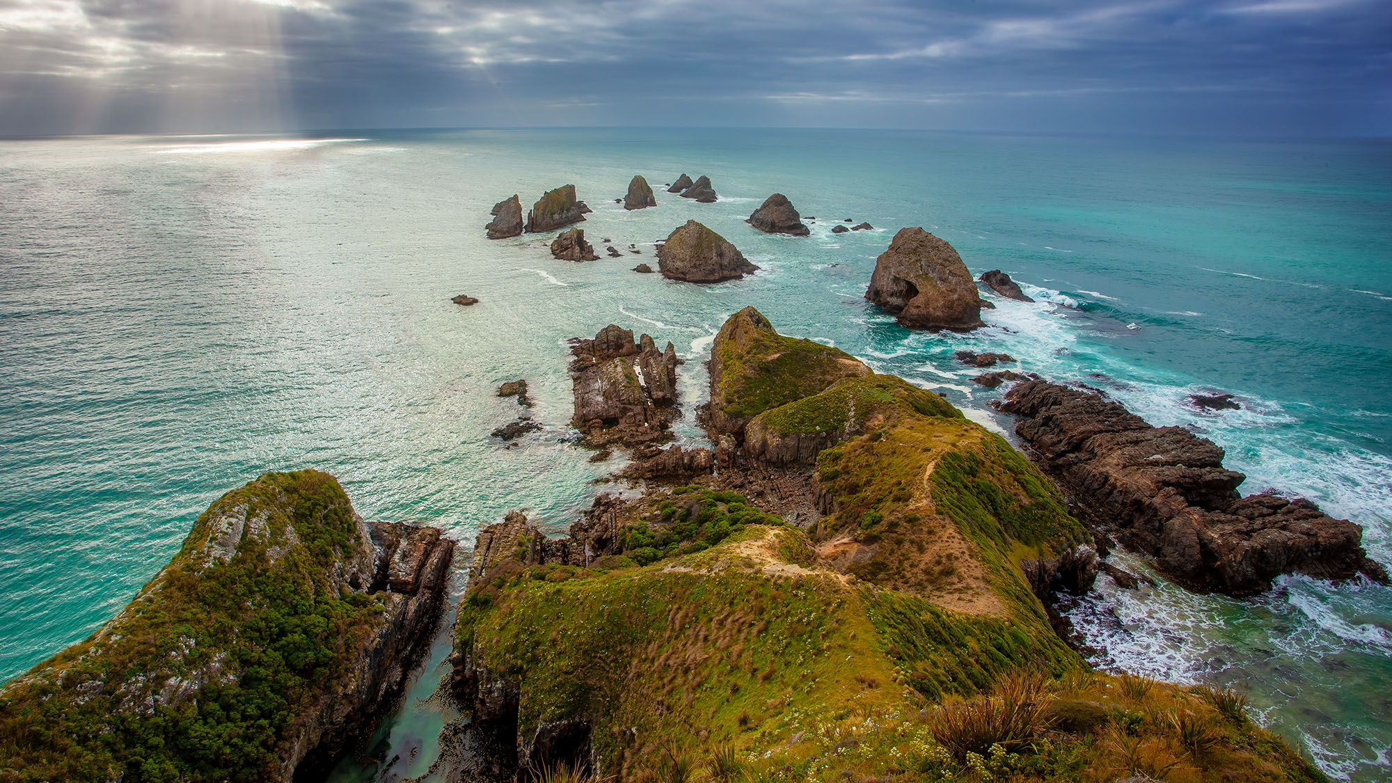 This photograph offers a panoramic view from Nugget Point, a remarkable location along the Otago coast in the Catlins, New Zealand...