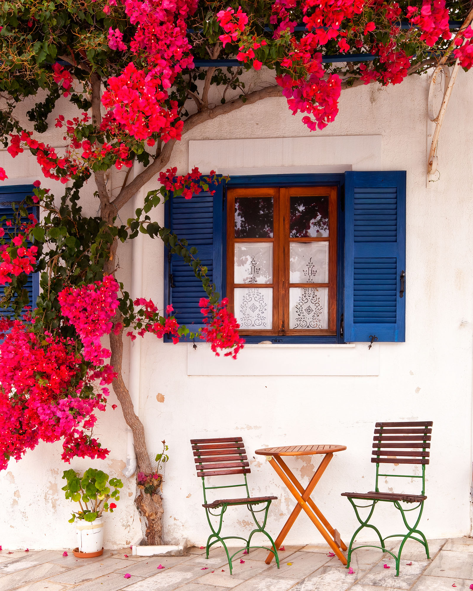In the picturesque town of Lefkes, Paros, Greece, I discovered a tranquil corner adorned with simple wooden seats and a small...