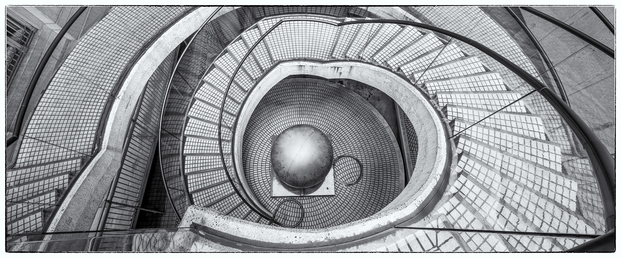 This black and white panorama captures the mesmerizing circular stairs of San Francisco's Embarcadero. Reminiscent of an M.C....