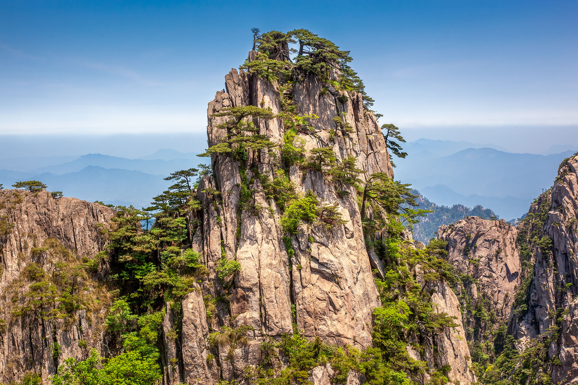 This image, captured in the East Sea Yellow Mountains of Mount Huangshan, China, unveils the rugged beauty of nature. In the...